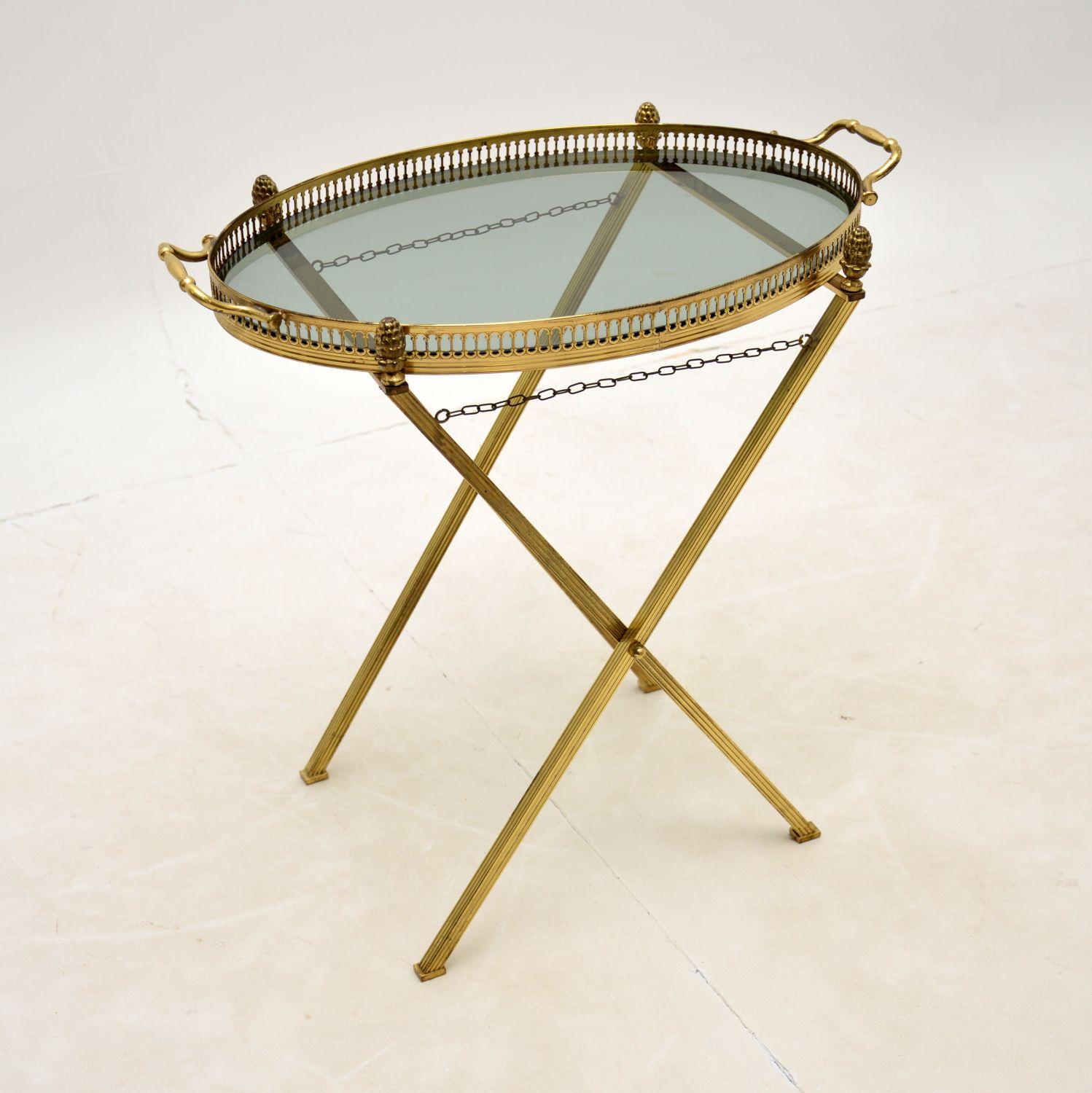 A beautiful and very unusual vintage folding side table in brass. This was made in France, it dates from the 1950-60’s.

The quality is excellent, this is solid brass throughout. The base has a folding mechanism to be stored away flat, and the