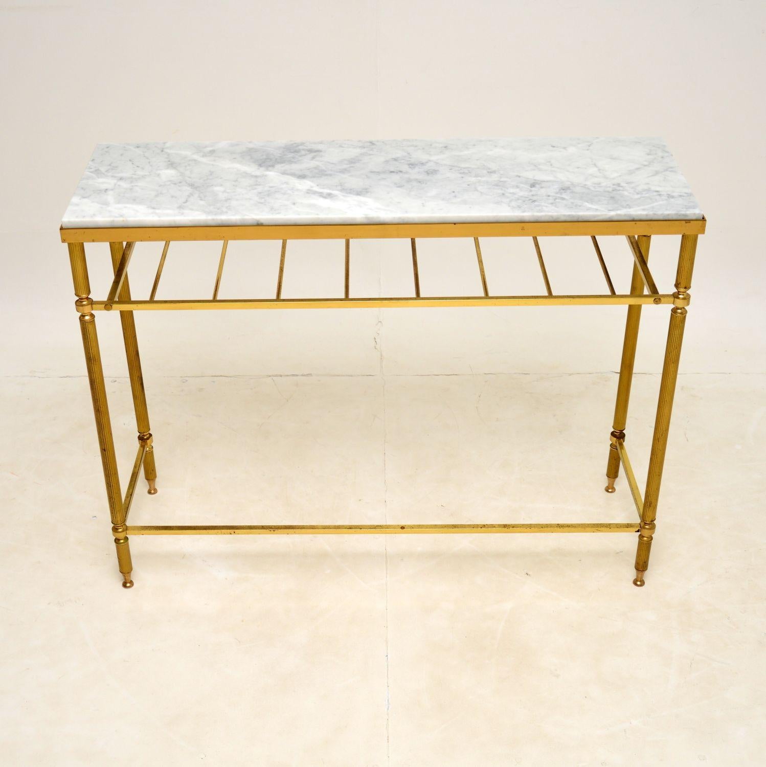 A stunning vintage console table with a solid brass frame and marble top. This was made in France, it dates from around the 1960’s.

It is very well made, with beautifully fluted legs and a stretchered base. We have had the white marble top newly