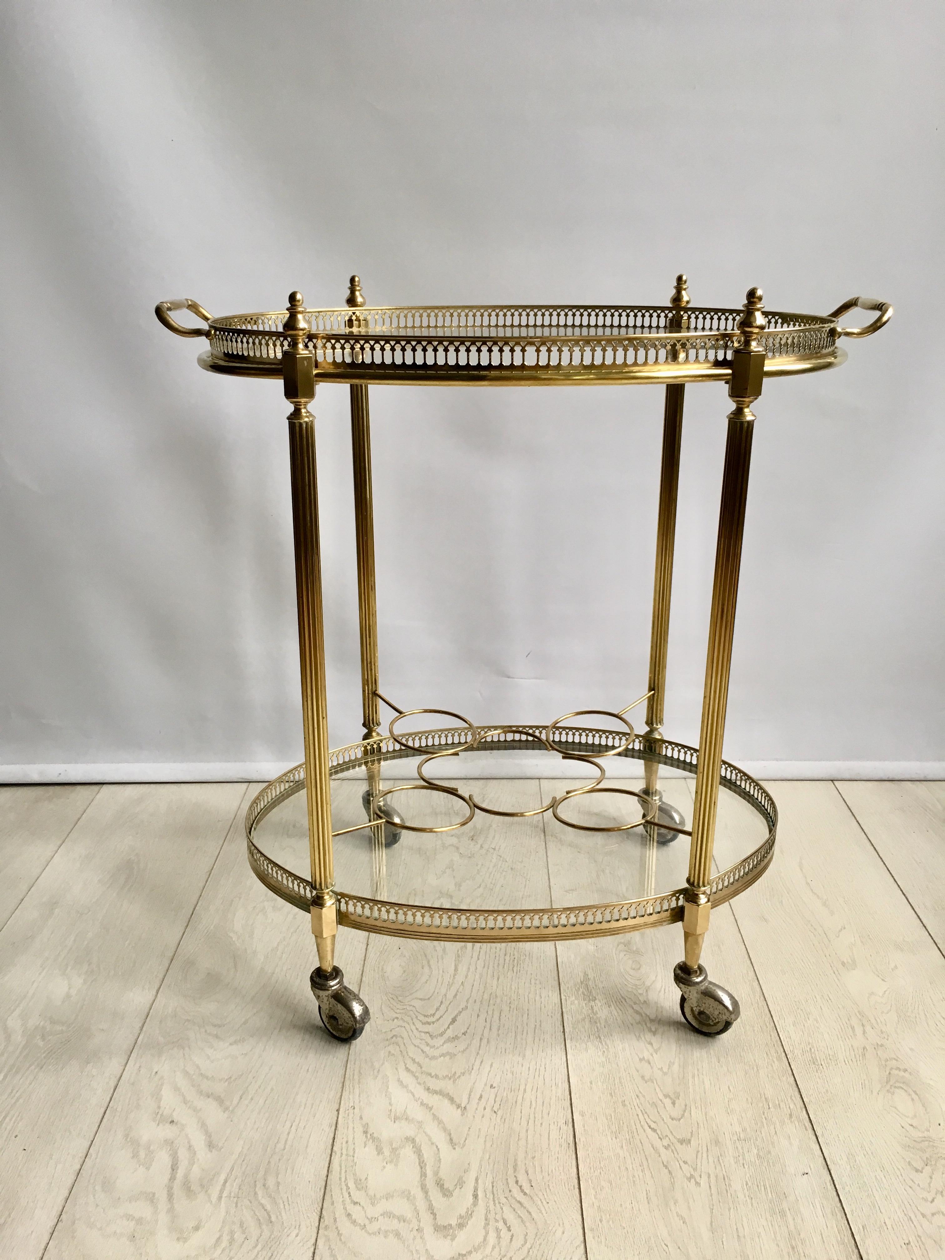 Attractive vintage drinks trolley from France, circa 1950.

Polished brass frame with lift off top tray and bottle holder to lower tier (can be removed)

Perfect for smaller spaces.

Overall dimensions: 61 cm wide, 40.5 cm deep and 65 cm tall