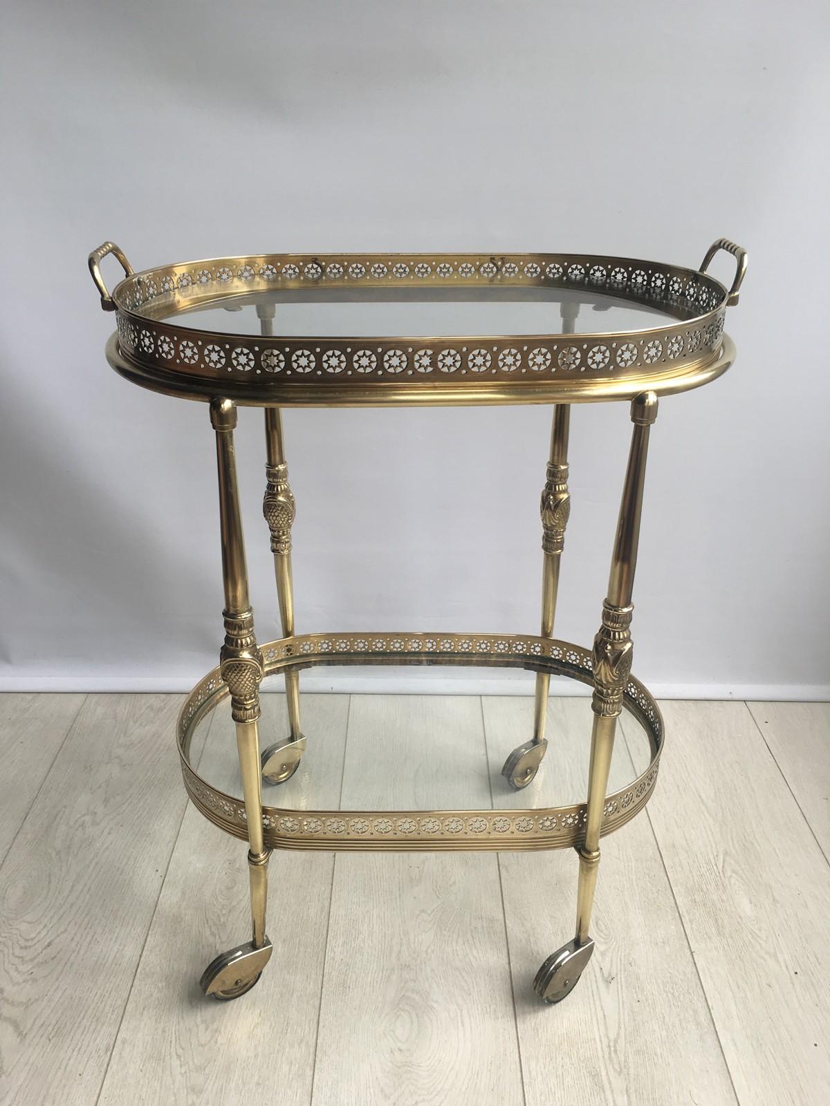 Vintage oval drinks trolley from France circa 1950

Polished brass frame with decorative fretwork and a lift off top tray 

Perfect for smaller spaces

Overall dims 54cm wide, 34cm deep and 70cm tall (64cm to glass).