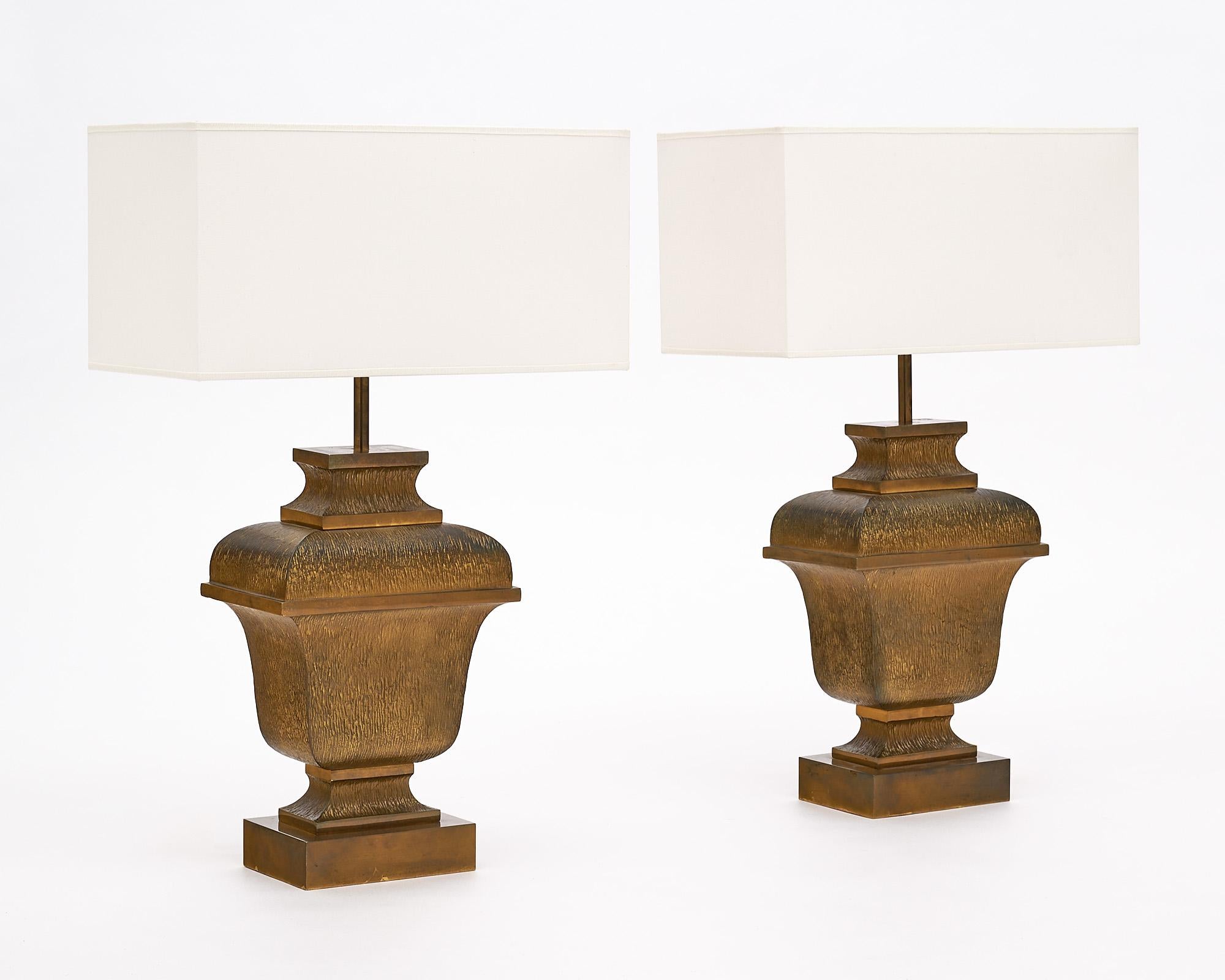 Pair of lamps from France by Maison Charles. This pair is sold brass, hand embossed. They have been newly wired to fit US standards.