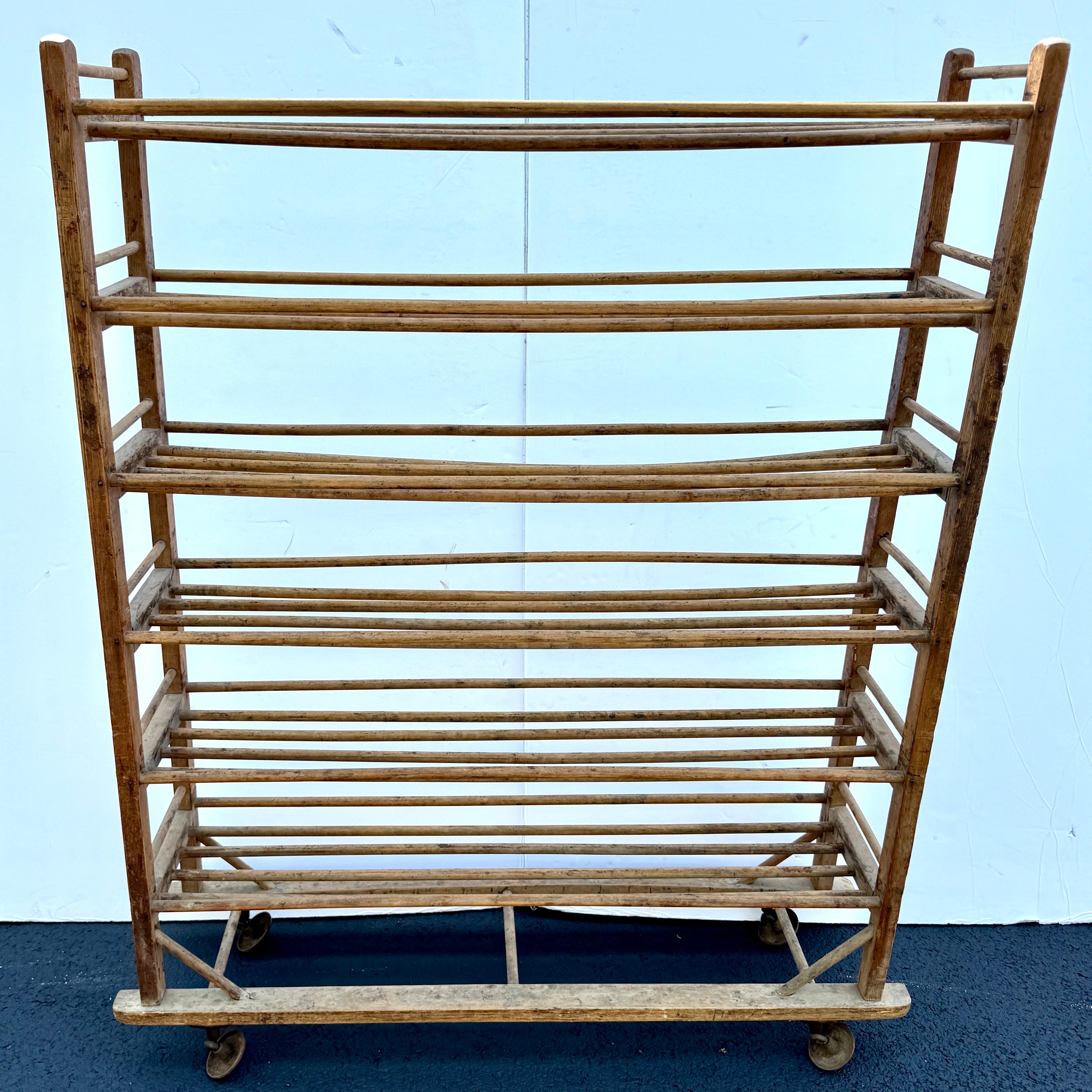 Vintage Wooden Bakers Bread and Pastry Cart on Discs as Wheels, France 1920’s. 
As seen through France these are one of a kind rolling bakers rack that make a wonderful addition to a home kitchen as well as restaurant or display in a retail setting. 