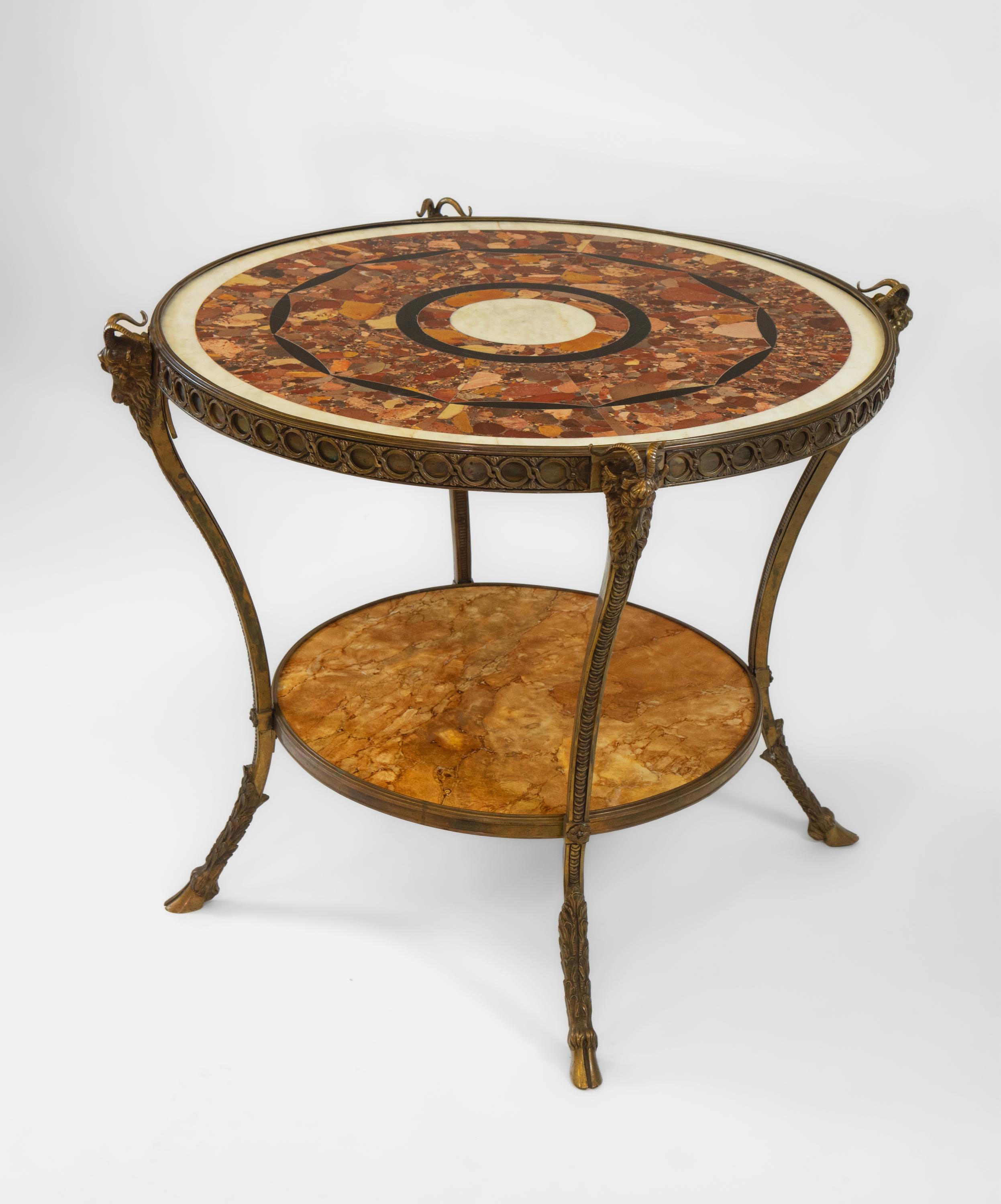 A stunning decorative French marble and bronze Guéridon. Circa 1950.

The table is of an elegant and attractive design, with the circular top featuring decorative segmented Brèche D' Alep marble. The table is supported by a bronze frame with a