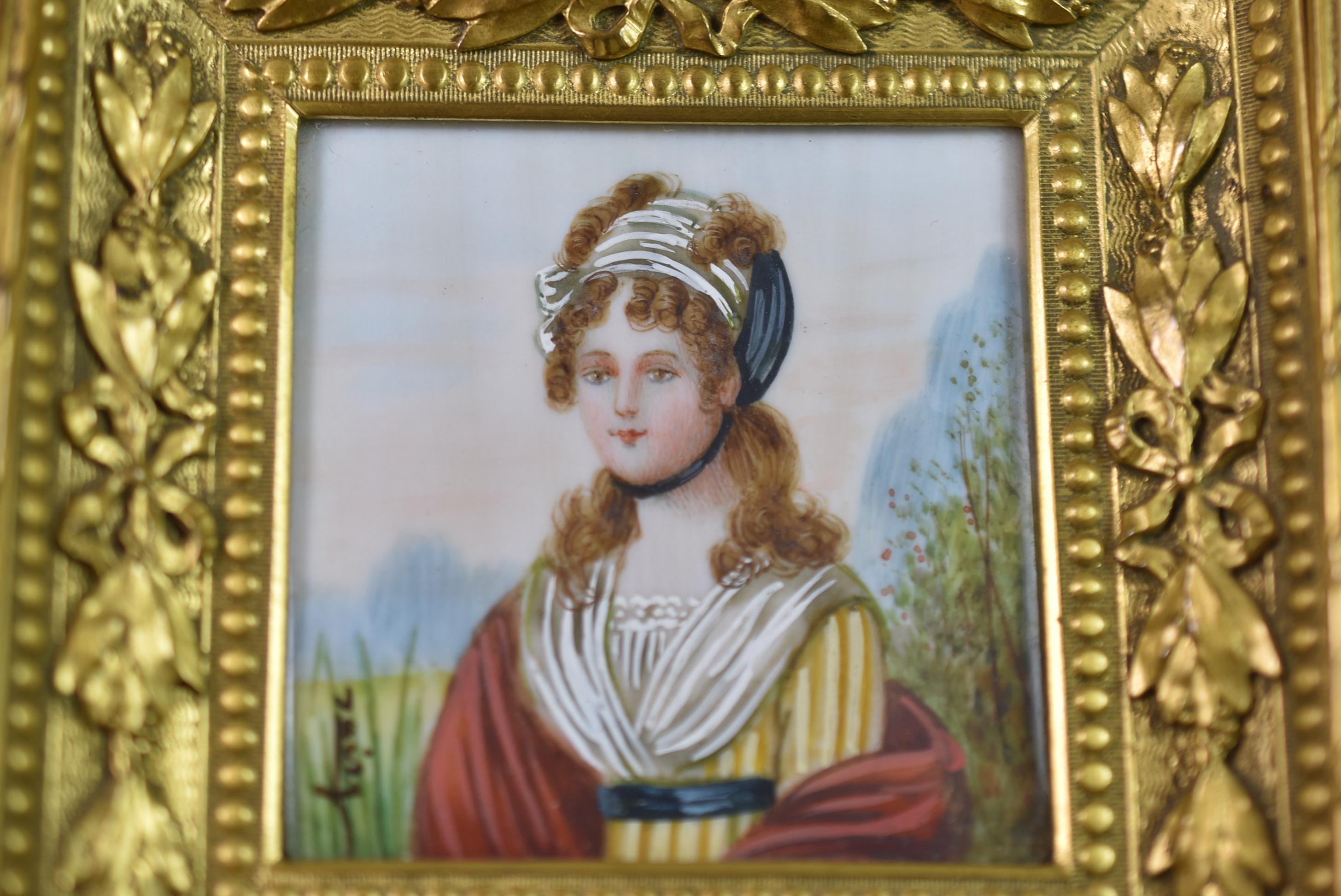 Hand painted miniature portrait of a woman in a yellow gown. French bronze frame with gold dore finish. Image measures 1.69
