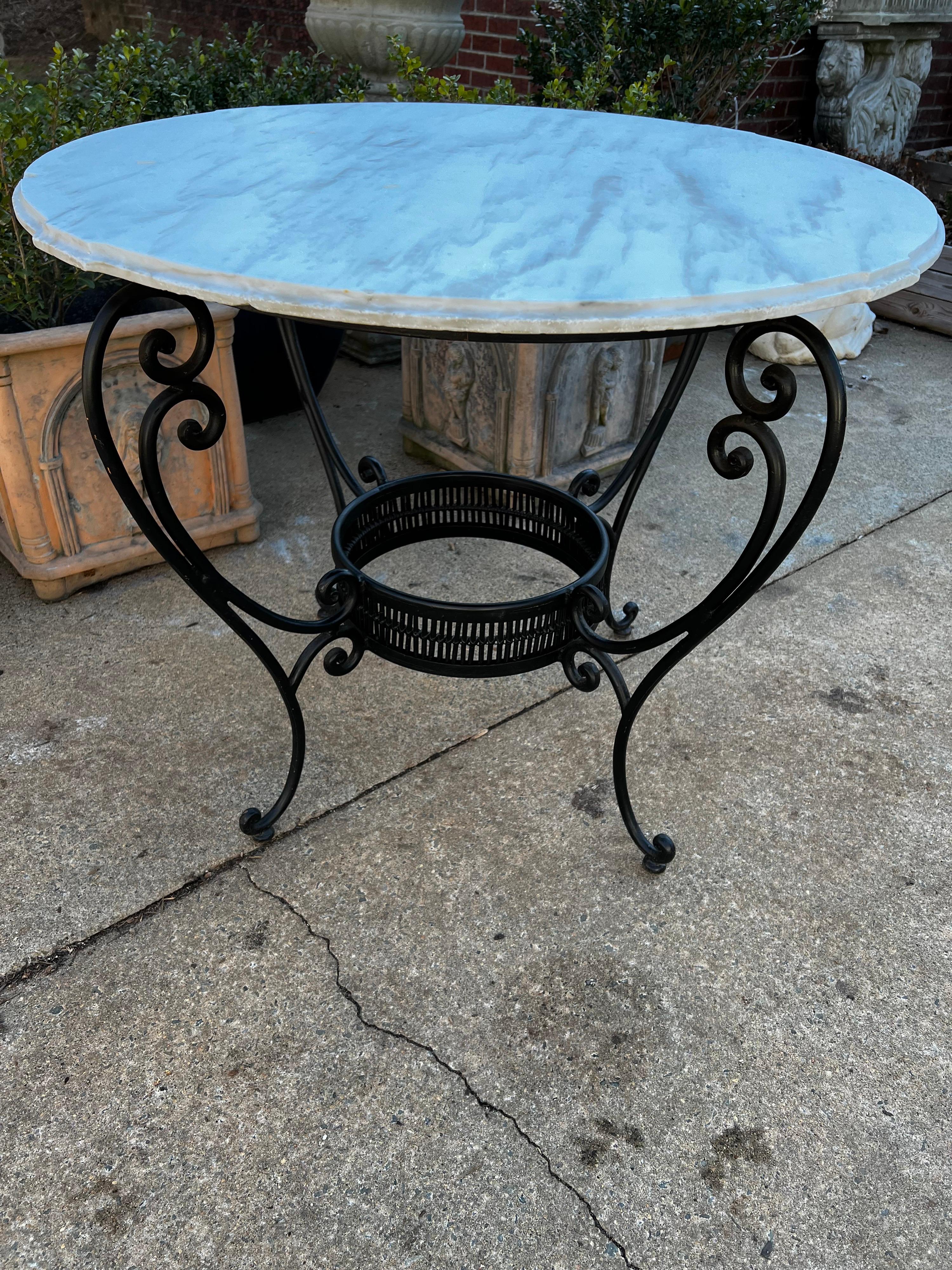 Ebony color metal table base with Italian Marble top. 
The metal ring on the bottom is lined with a bamboo type wood also in ebony finish.
This would make wonderful entry foyer, center hall table. Garden table, garden dining table, patio or porch