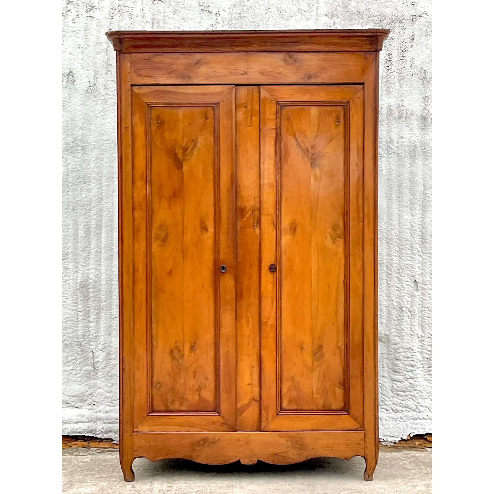 A fantastic vintage Boho Armoire. Incredible wood grain detail on a soaring high frame. Removable boomer for easy movement. Beautiful all over patina from time. Interior private cabinet. Acquired from a Palm Beach estate.