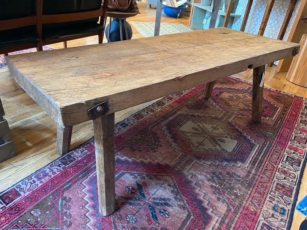 A vintage butcher block table crafted into an intimate coffee table. Heavy French oak with original metal embellishments (screw and washers).