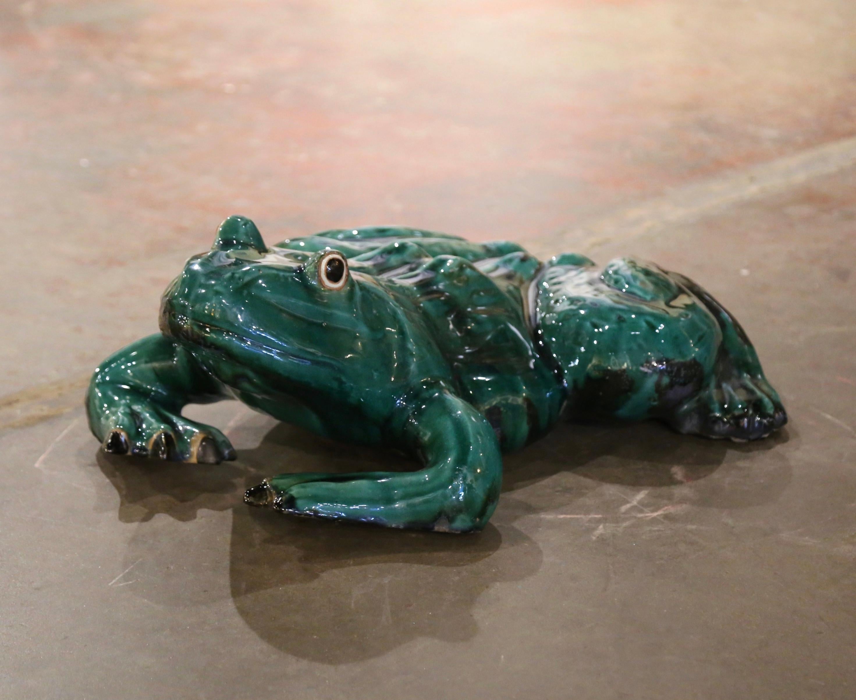 Decorate a garden or a backyard with this large frog. Crafted in southern France and made of terracotta, the reptile sculpture is a captivating example of ceramic artistry, featuring a vibrant green glaze that brings a sense of liveliness to the