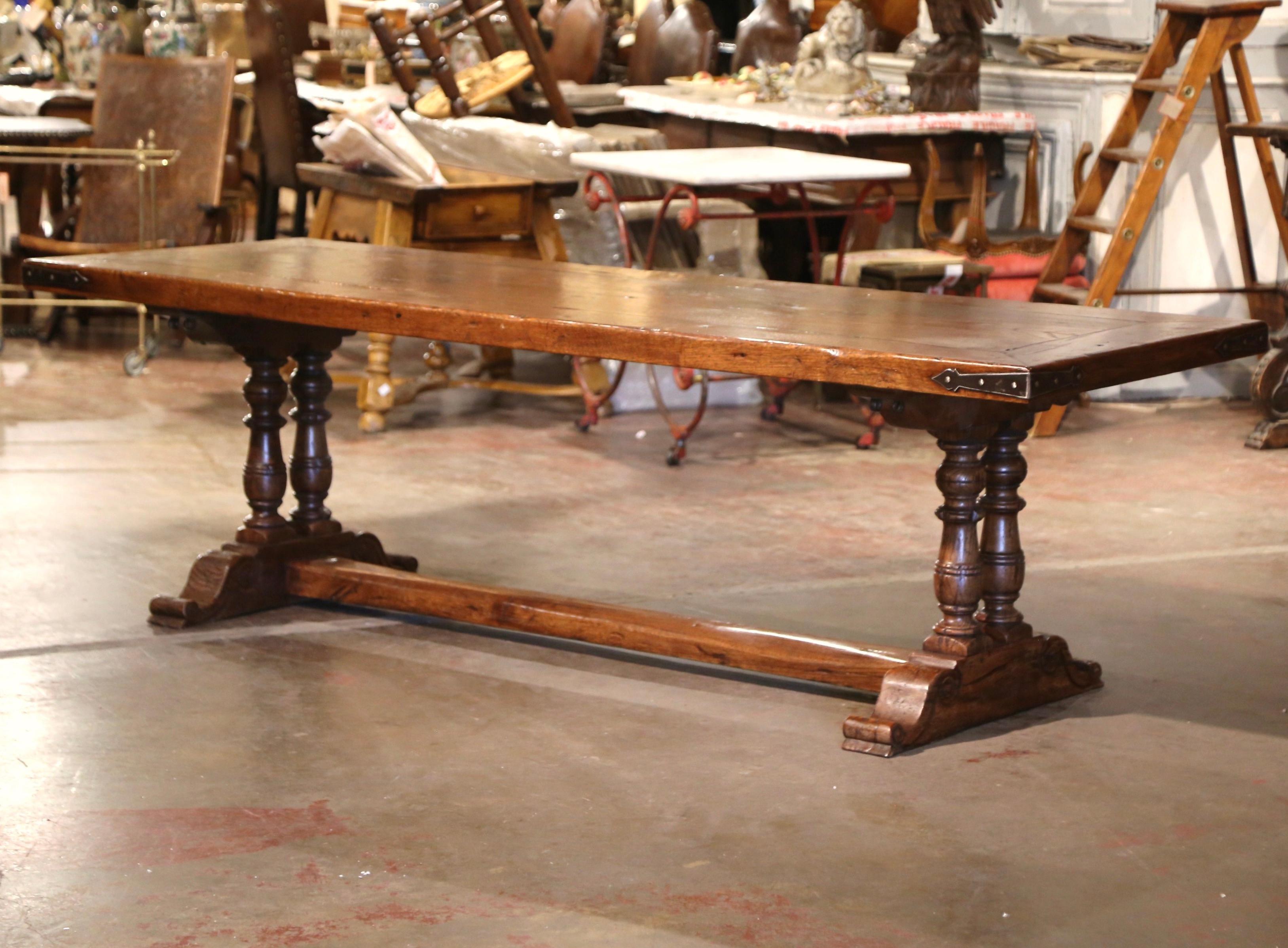 This long antique dining room table was crafted in the French Pyrenees, southwest France, near the Spanish border. Built with 18th century chestnut and oak timber and over 8 feet in length, the table stands on two hand carved double-baluster legs