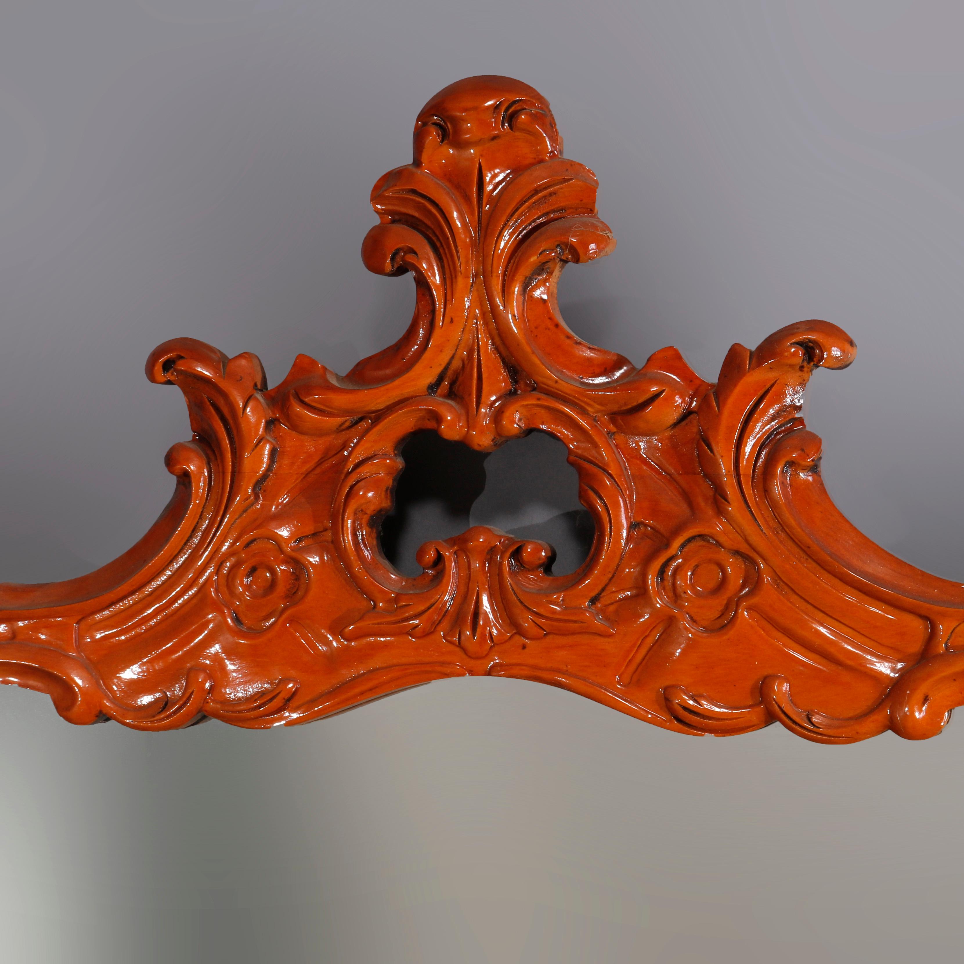 A vintage French wall mirror offers deeply carved scrolled foliate and gadroon form frame with pieced cartouche, 20th century

Measures: 47
