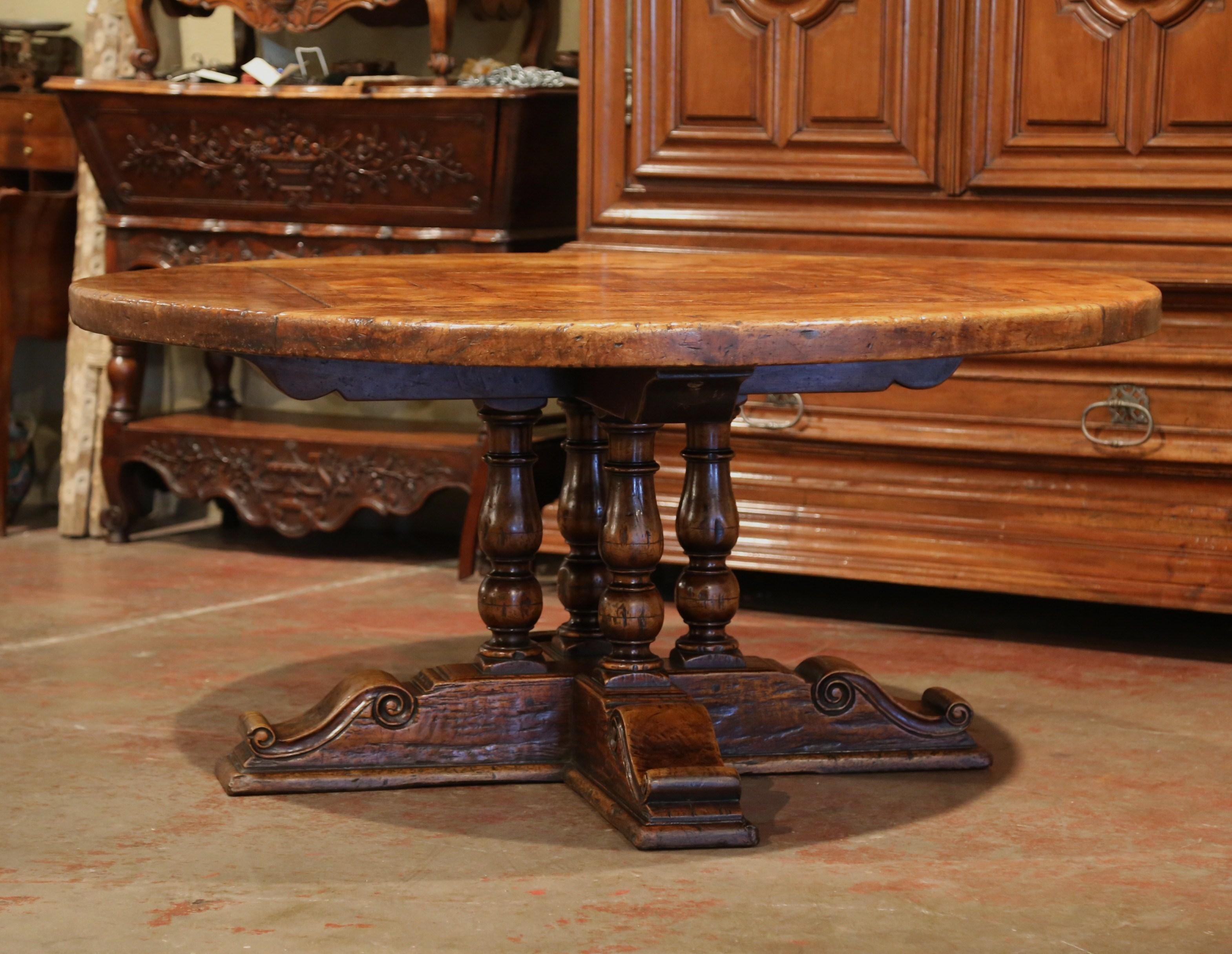 This large fruitwood table for six to ten people, would make an impressive addition to any dining room or breakfast room. Crafted in the Pyrenees mountains of France half a century ago, the thick round surface features a parquet and geometric decor