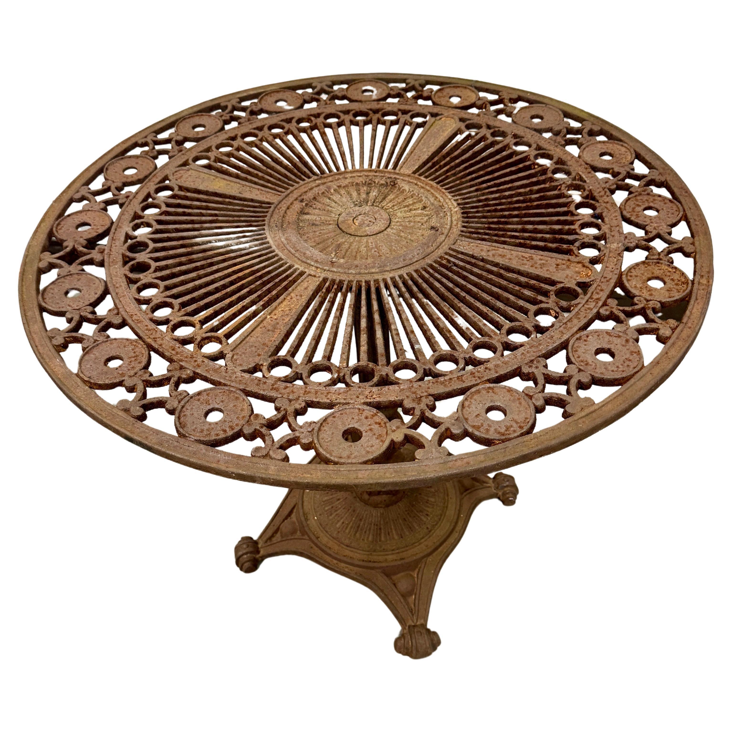 Cast Iron Garden Patio Table, 1920's France

This charming and sturdy cast iron table can be used either indoors or outside. 
The table is made of cast iron with attention to details, the top of the table is adorned with a sun-like circular elements