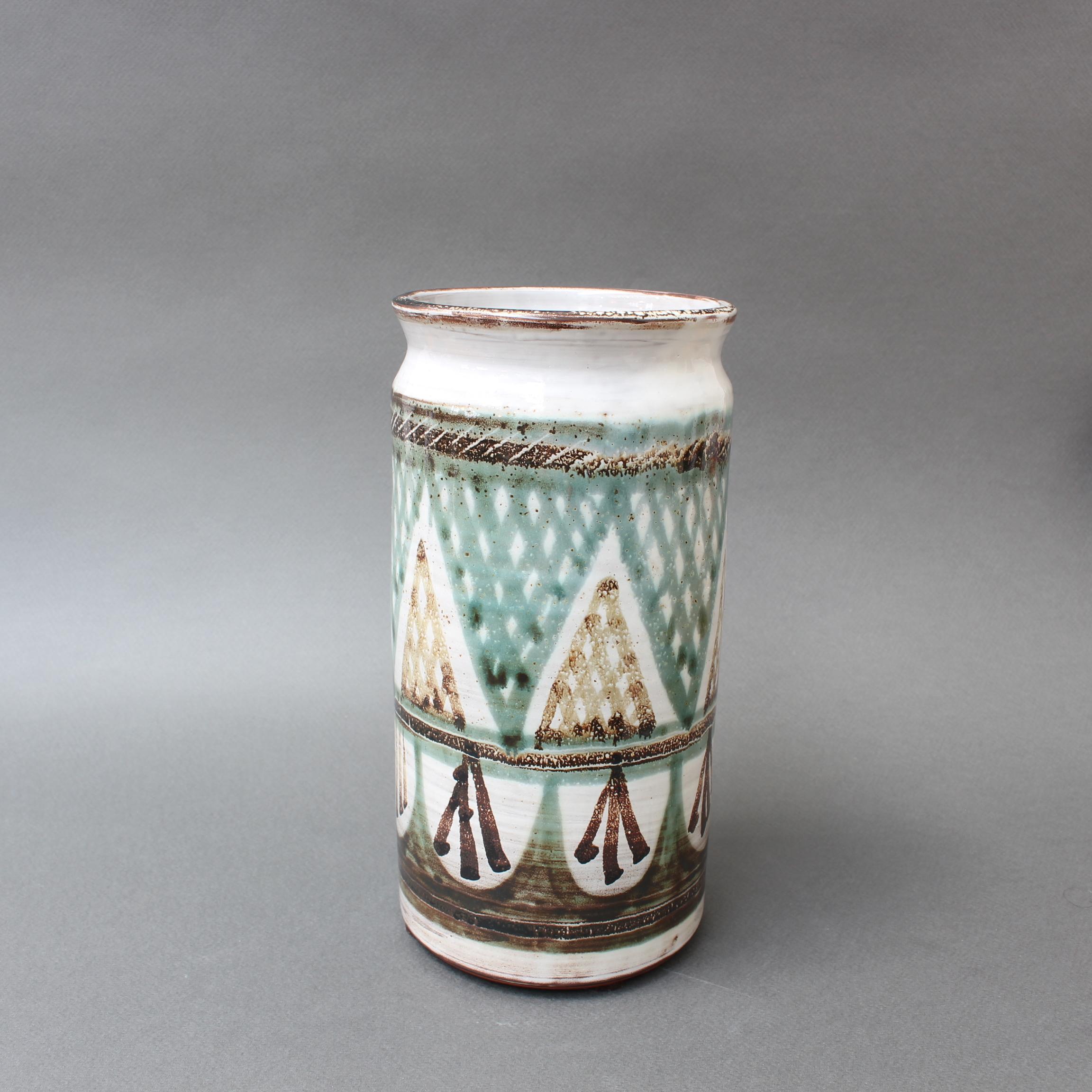 French decorative ceramic vase by Michel Barbier (circa 1960s), Vallauris, France. Abstract triangular shapes with cross-hatch patterns in jade green and dark brown encircle the vase. At the top of the decorated portion, a repeating rope pattern