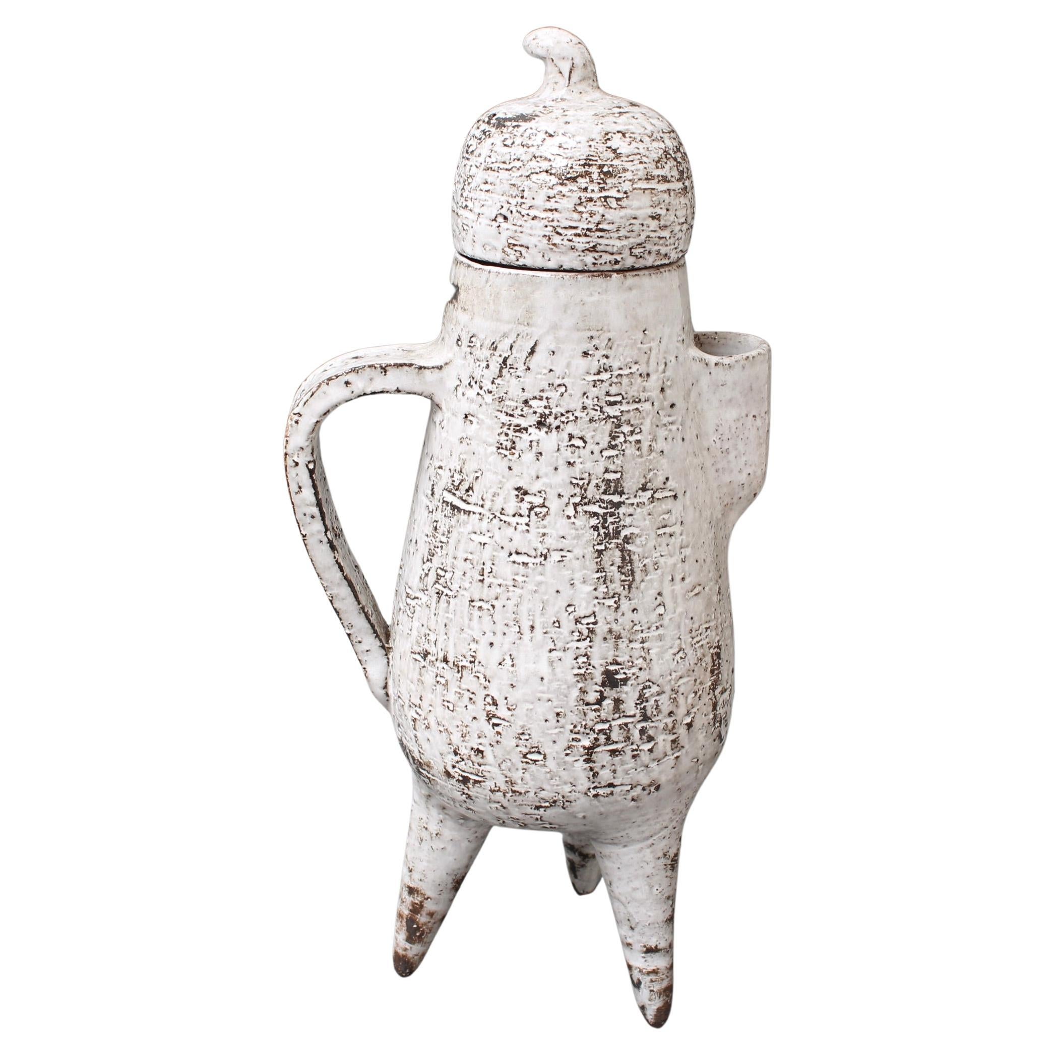 Vintage French ceramic jug by Gérard Hofmann (circa 1960s). A three-legged, elongated pear with stem on the lid makes for a piece so unique it is unlike any other. The surface is in one of his trademark finishes, a chalky white enamel with elements