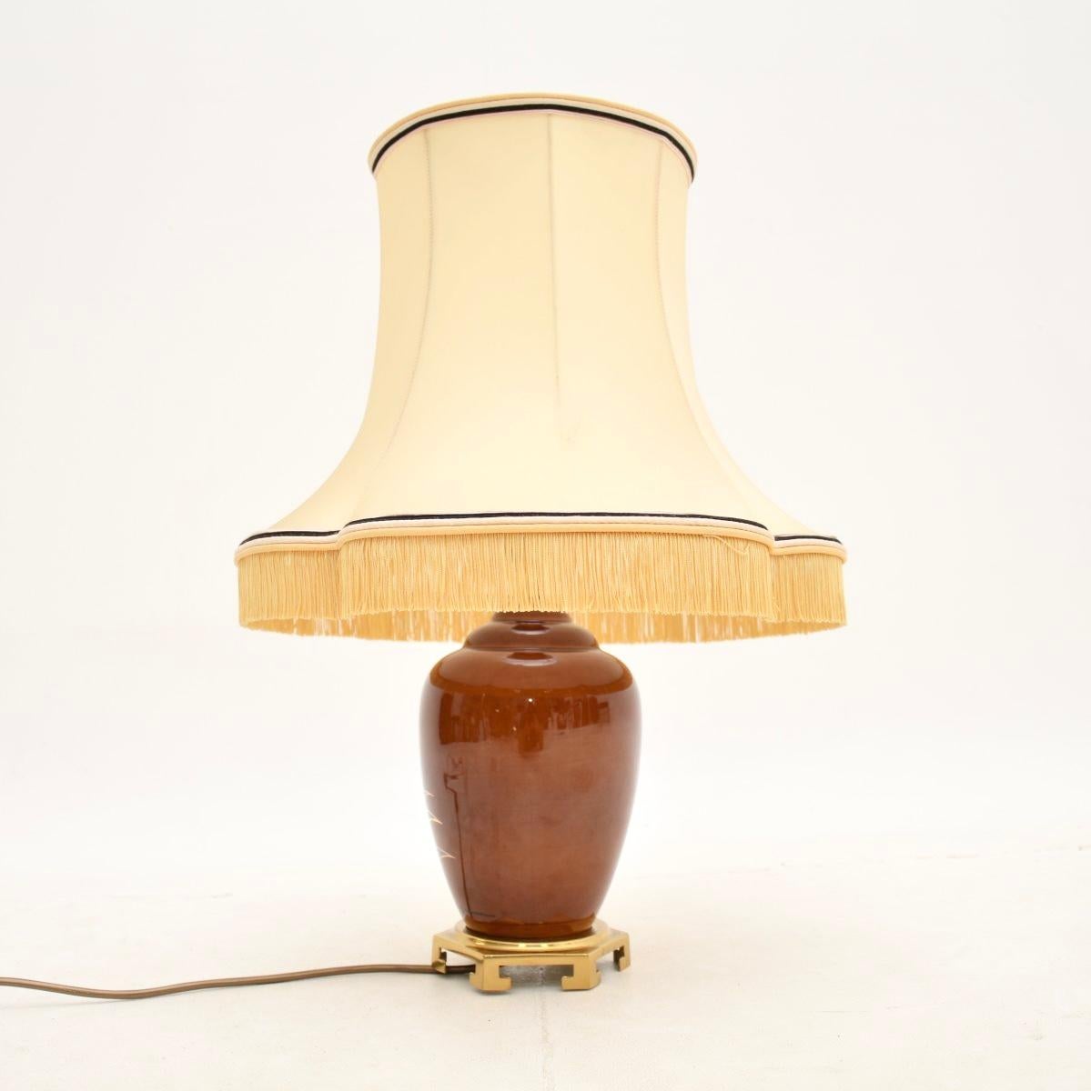 An absolutely stunning vintage French ceramic table lamp, dating from the 1970’s.

This is of superb quality, it is a lovely size and has gorgeous decorations. It is hand painted and signed by the artist, the lamp sits on a stunning brass oriental