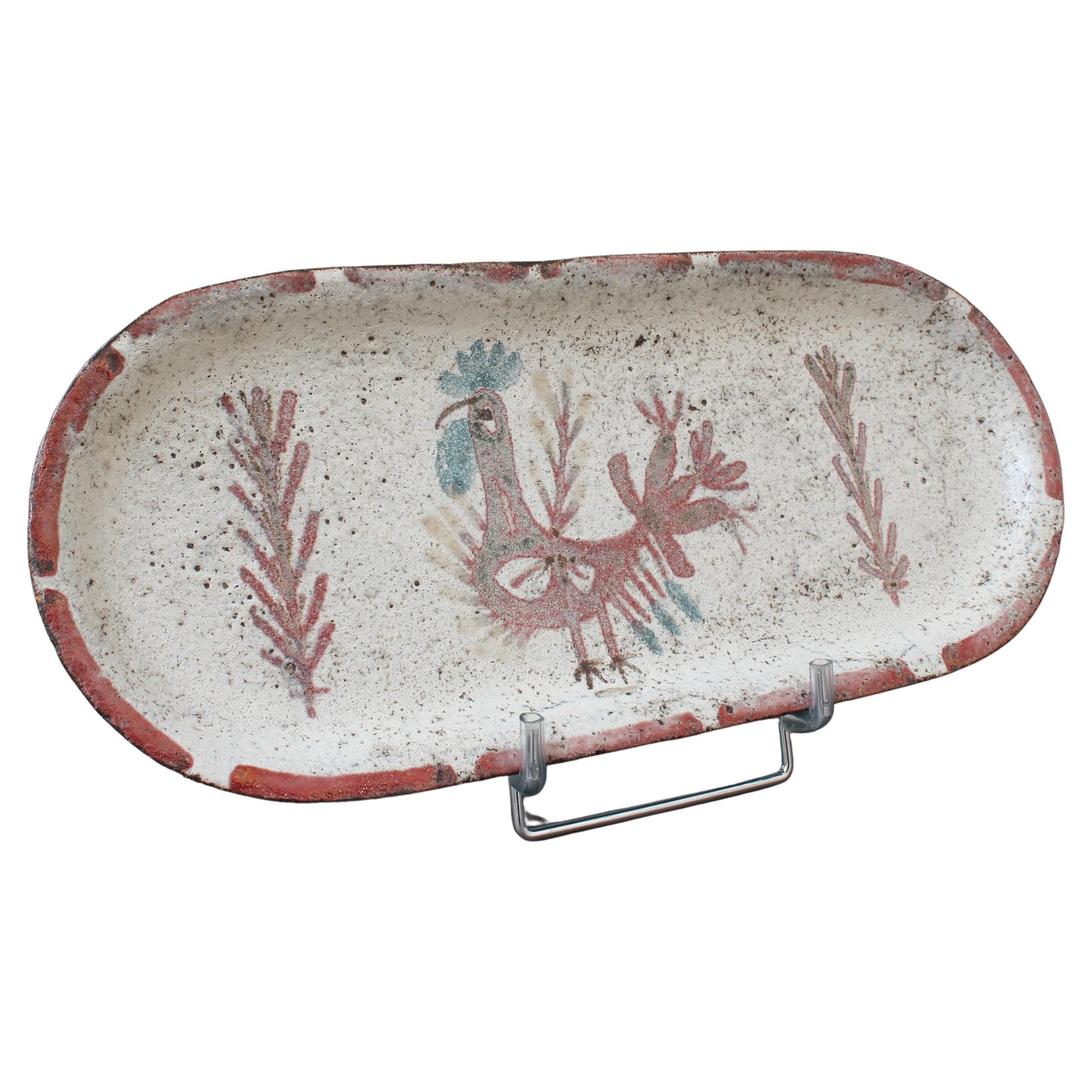 Mid-century French ceramic tray by for Le Mûrier (circa 1960s). Long-shaped tray with raised rim and rounded ends in rustic earthenware and decor of a French coq motif flanked by Reynaud's stylised foliage. The rooster is in the muted, mesmerising