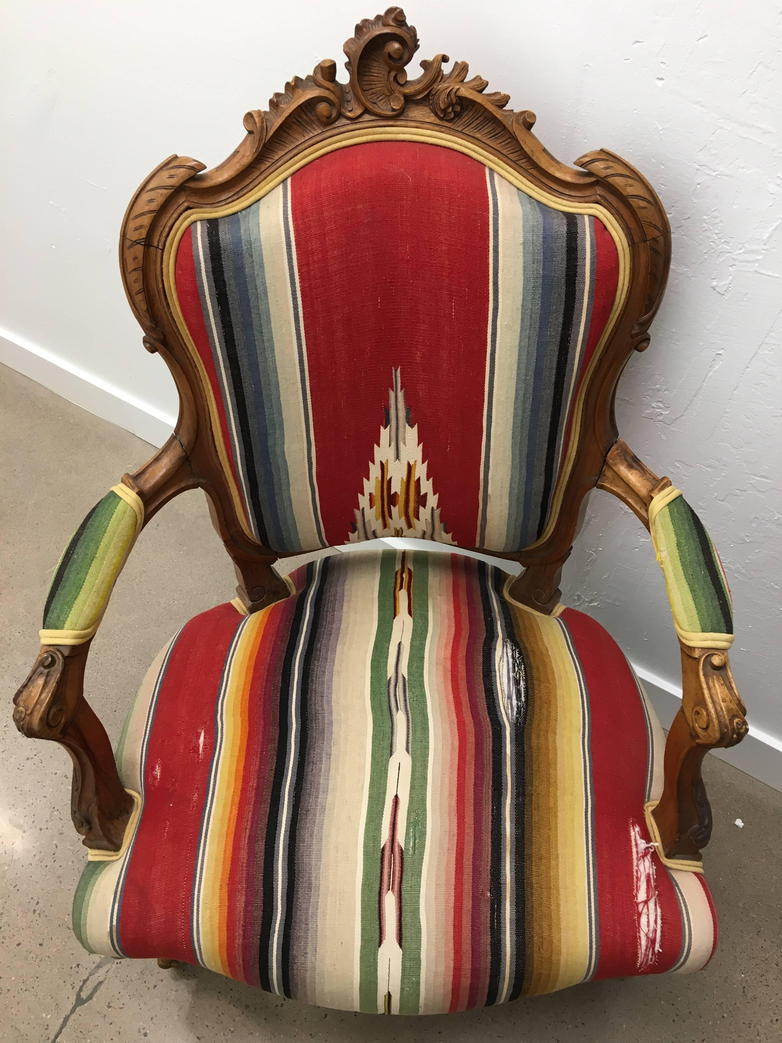 A charming French bergere chair upholstered in a timeworn vintage Mexican serape fabric. A lovely corner chair addition in any space.