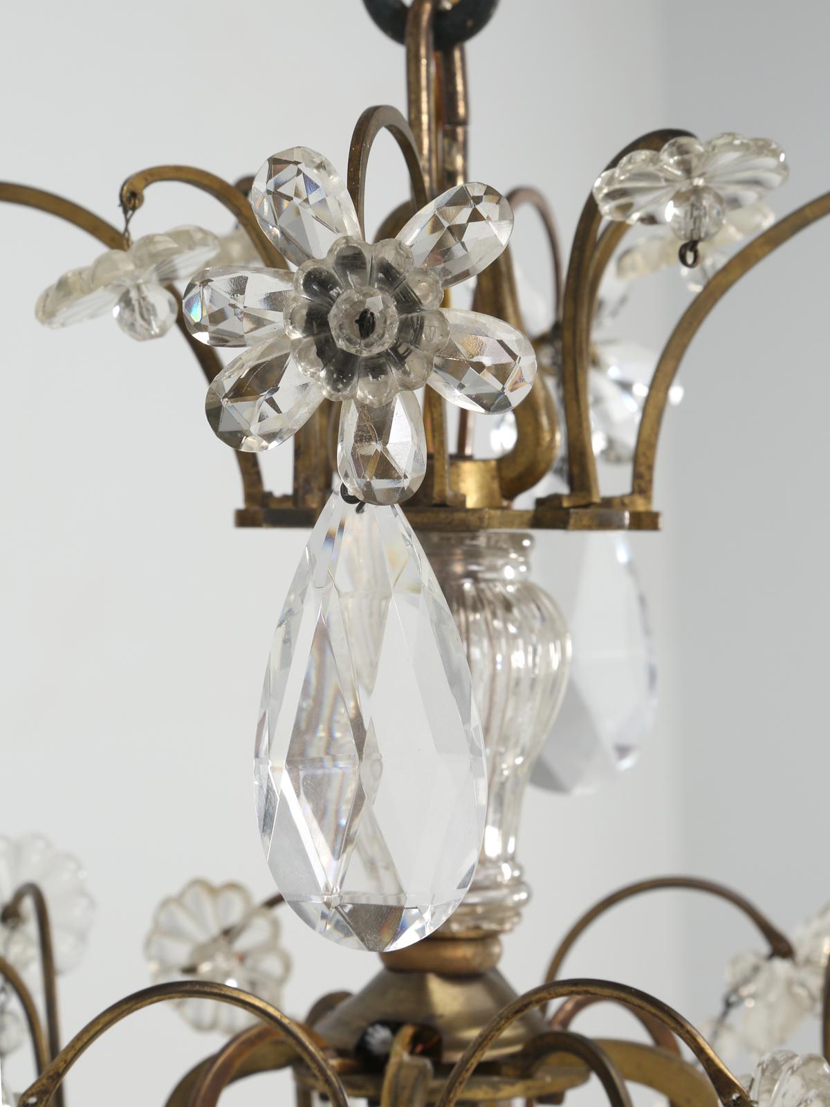 Vintage French Maison Jansen-style Bronze and Crystal 8-light Chandelier, featuring crystal links, pendants, faceted prisms, rosettes and flowers. Re-wired and tested to use immediately. Beautifully made and clearly a step above most of the French
