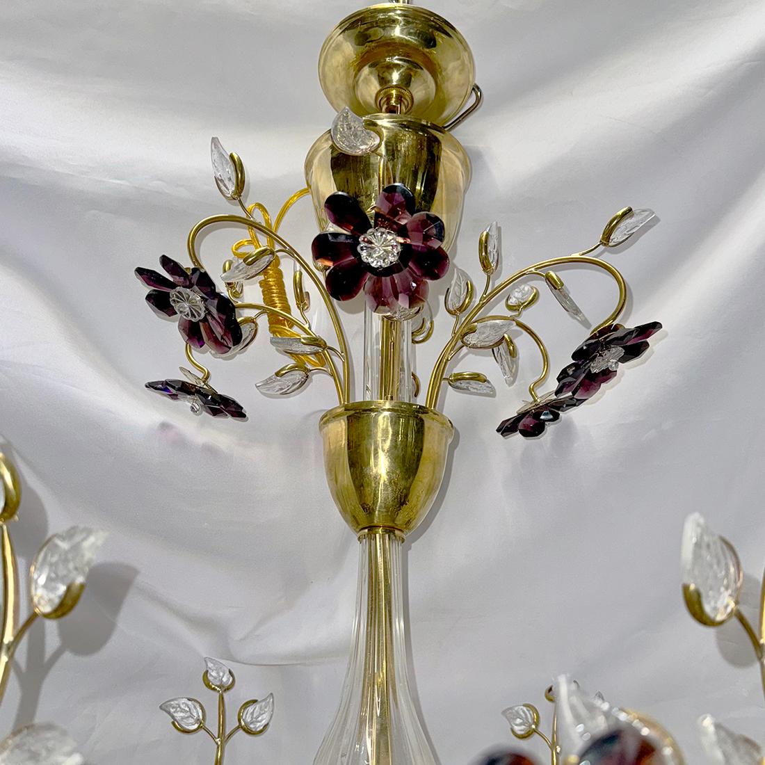 A circa 1950's French gilt chandelier with inset clear and amethyst crystals. 8 chandelier lights.

Measurements:
Present drop: 40
