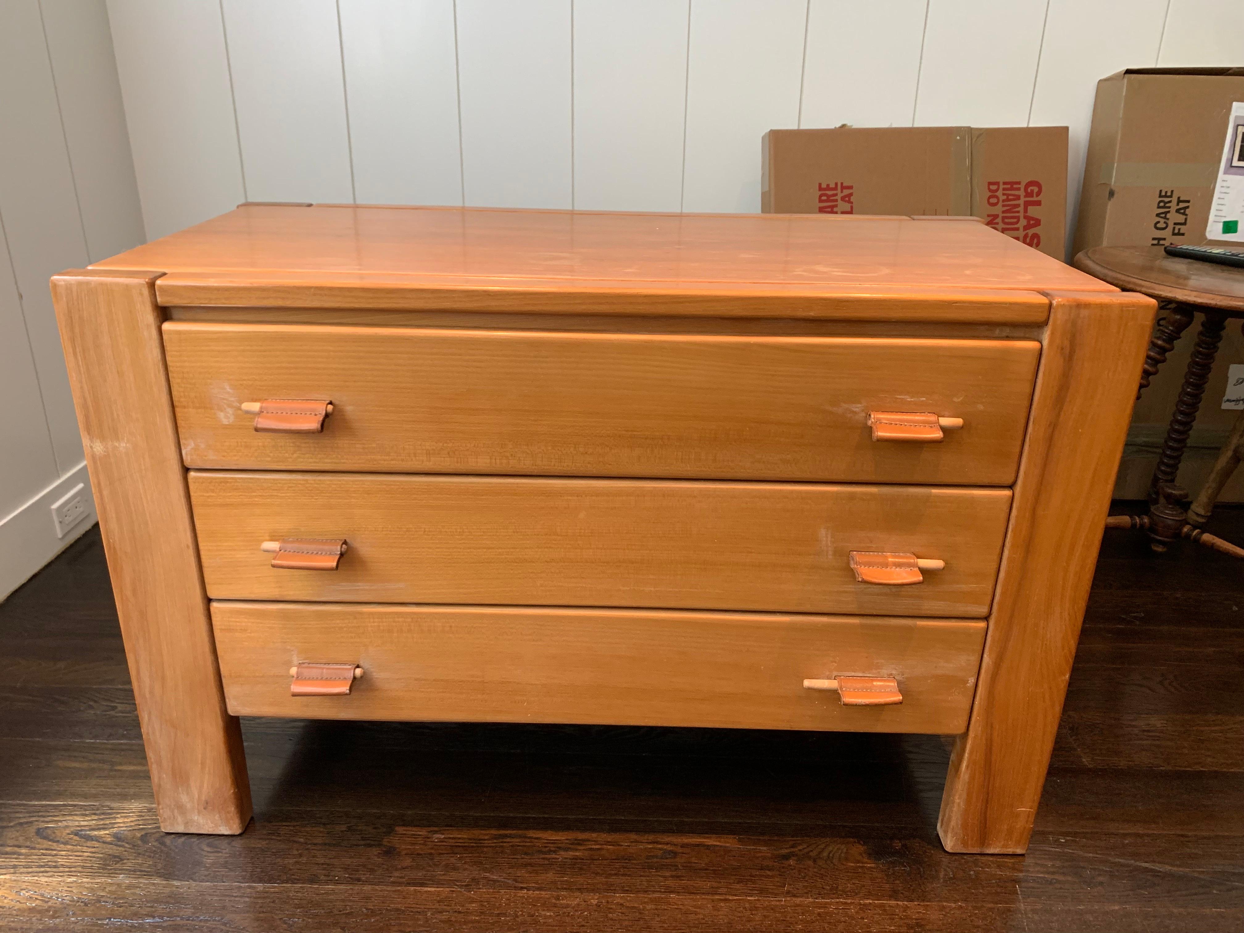 Vintage three drawer wooden chest of drawers with leather pulls. In good vintage condition with some signs of wear as seen in the images.