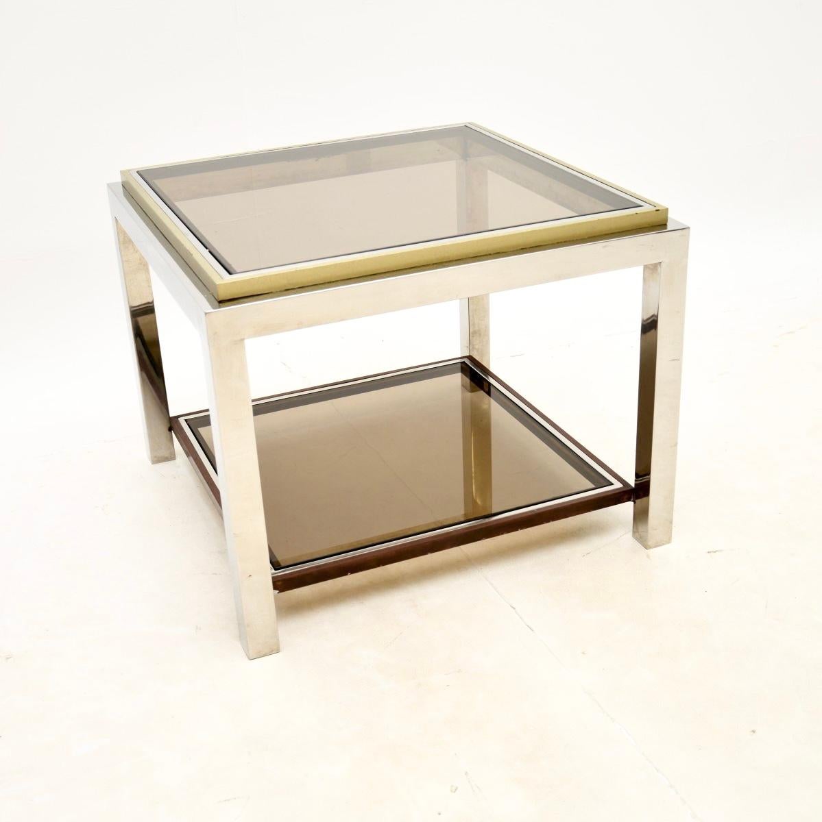A fantastic vintage French chrome and brass side / coffee table, dating from the 1970’s.

This is of outstanding quality, the frame is extremely well made, thick and heavy. The chrome has brass finished trim around the top and lower tier, with
