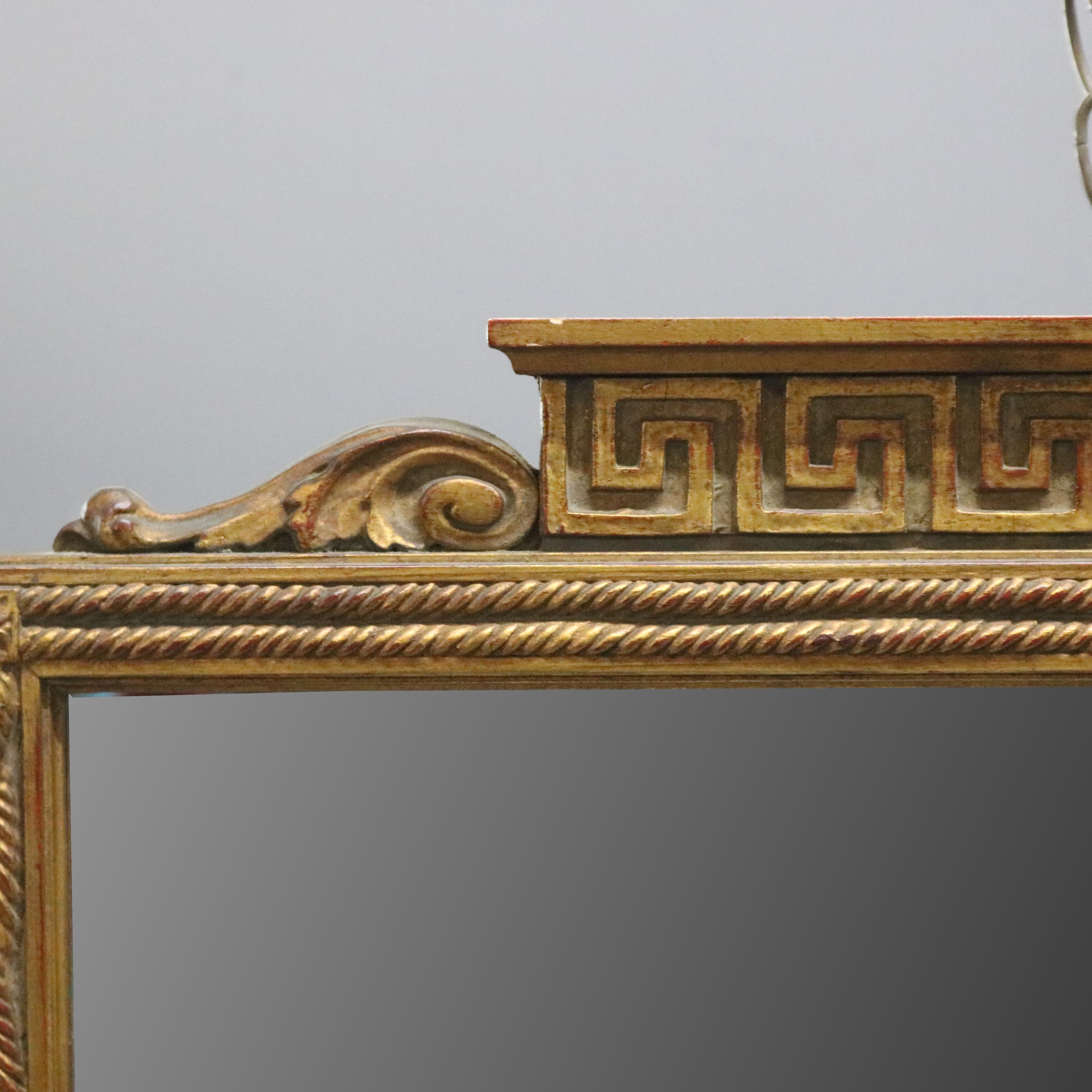 A vintage French Classical wall mirror offers giltwood frame having Greek Key crest over rope and tassel with flanking acanthus elements, rosette cornering, 20th century.

***DELIVERY NOTICE – Due to COVID-19 we are employing NO-CONTACT PRACTICES in