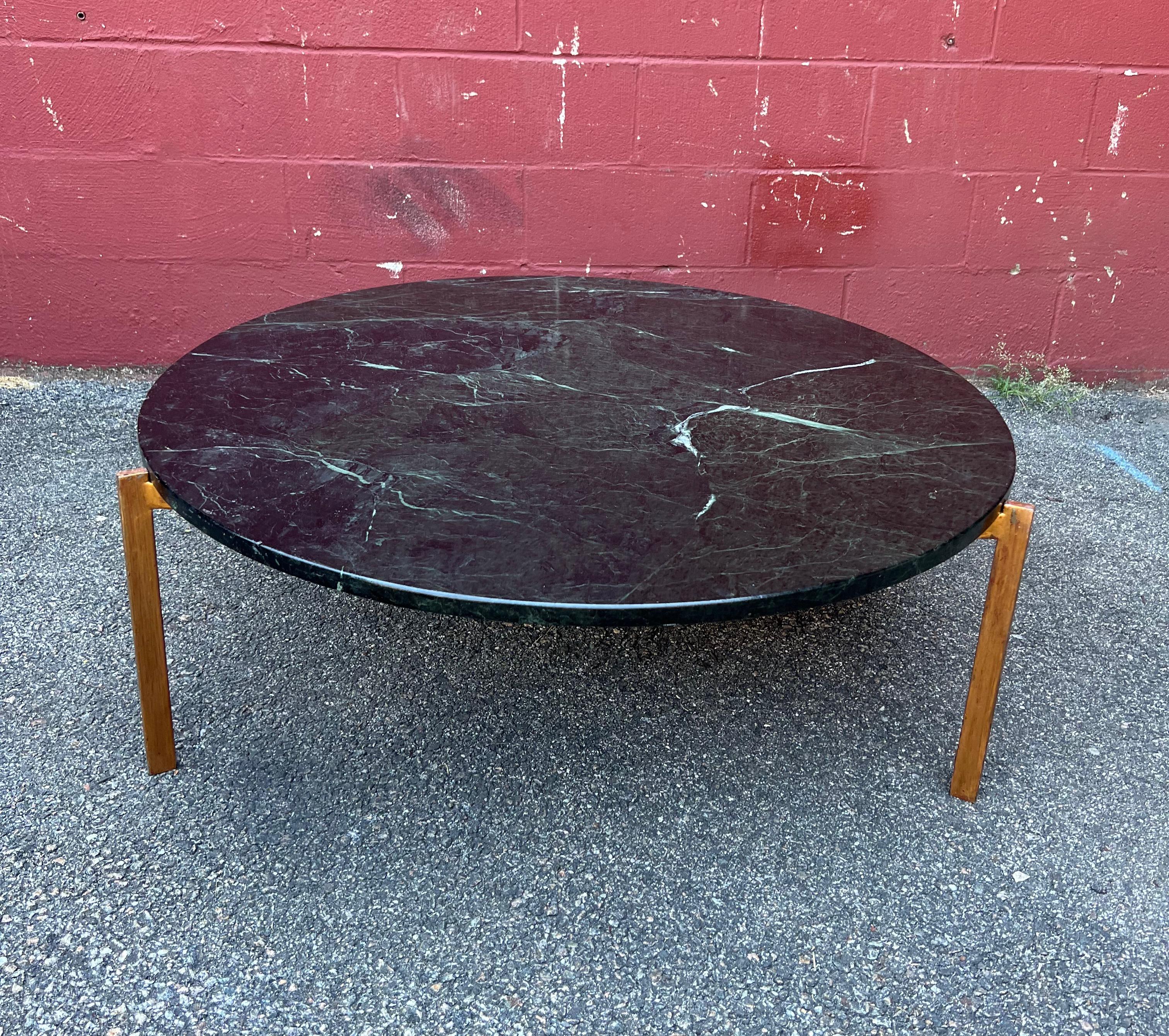 A very chic Mid-Century Modern coffee with a beautiful round green  veined marble resting on a gilt triangular base. The marble top is securely  held in place by 3 insets on each corner of the patinated gilt iron base. Overall  the table is in great