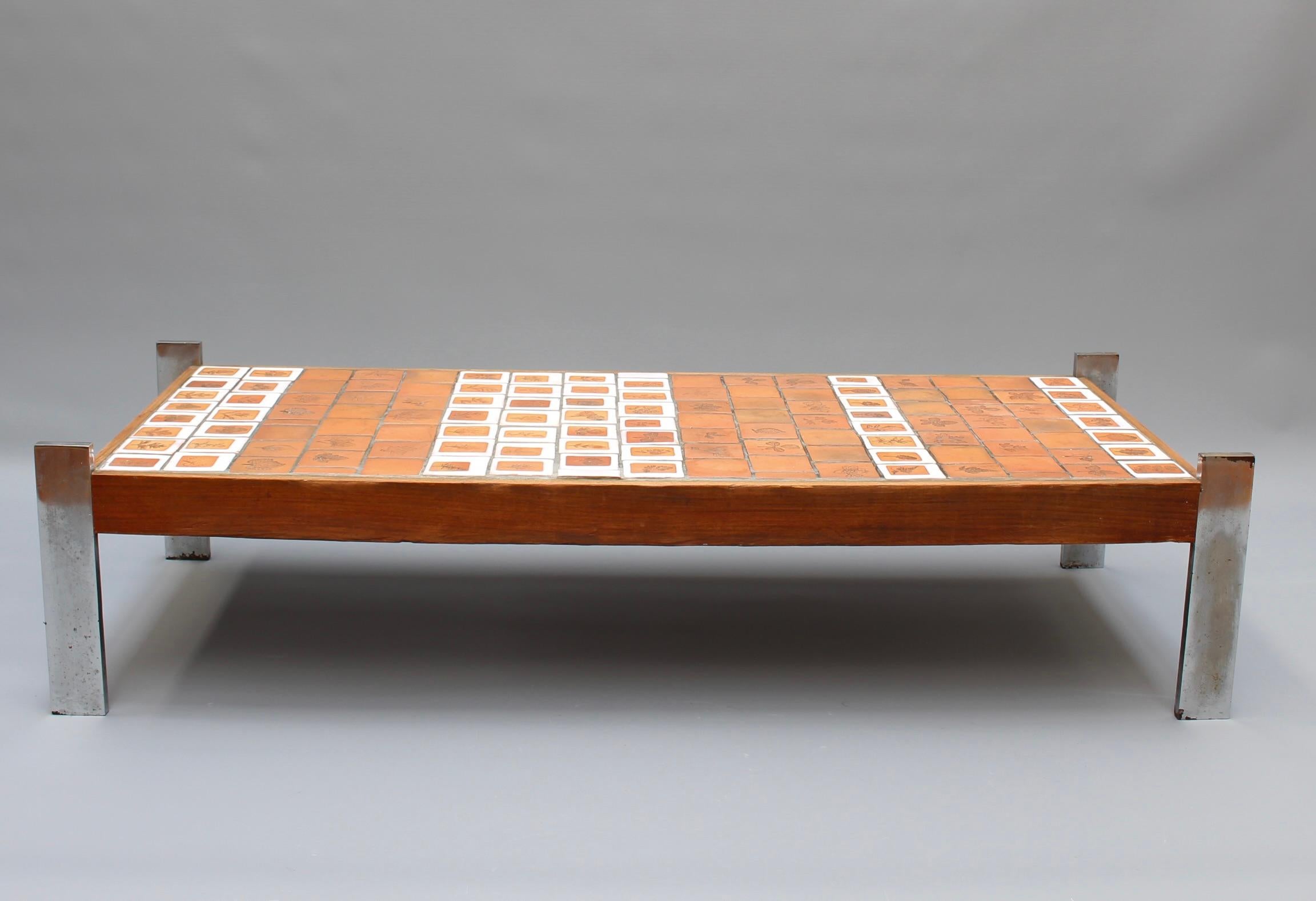 Coffee table with leaf motif earthenware tiles by Roger Capron (circa 1970s). This charming rectangular-shaped low table is a quintessential example of collectible Capron. There are nature-themed tiles with a multitude of beautiful leaves impressed