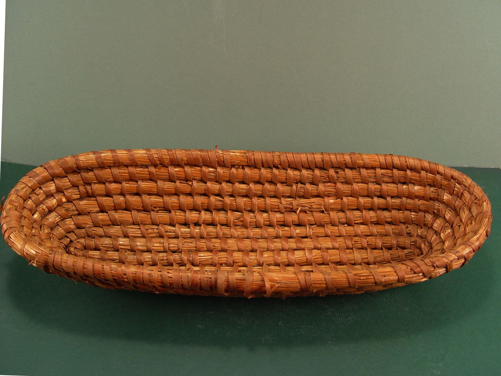 Vintage circa 1920s.coiled rye, straw French bread basket. Some loose and frayed wrappings at top edge.