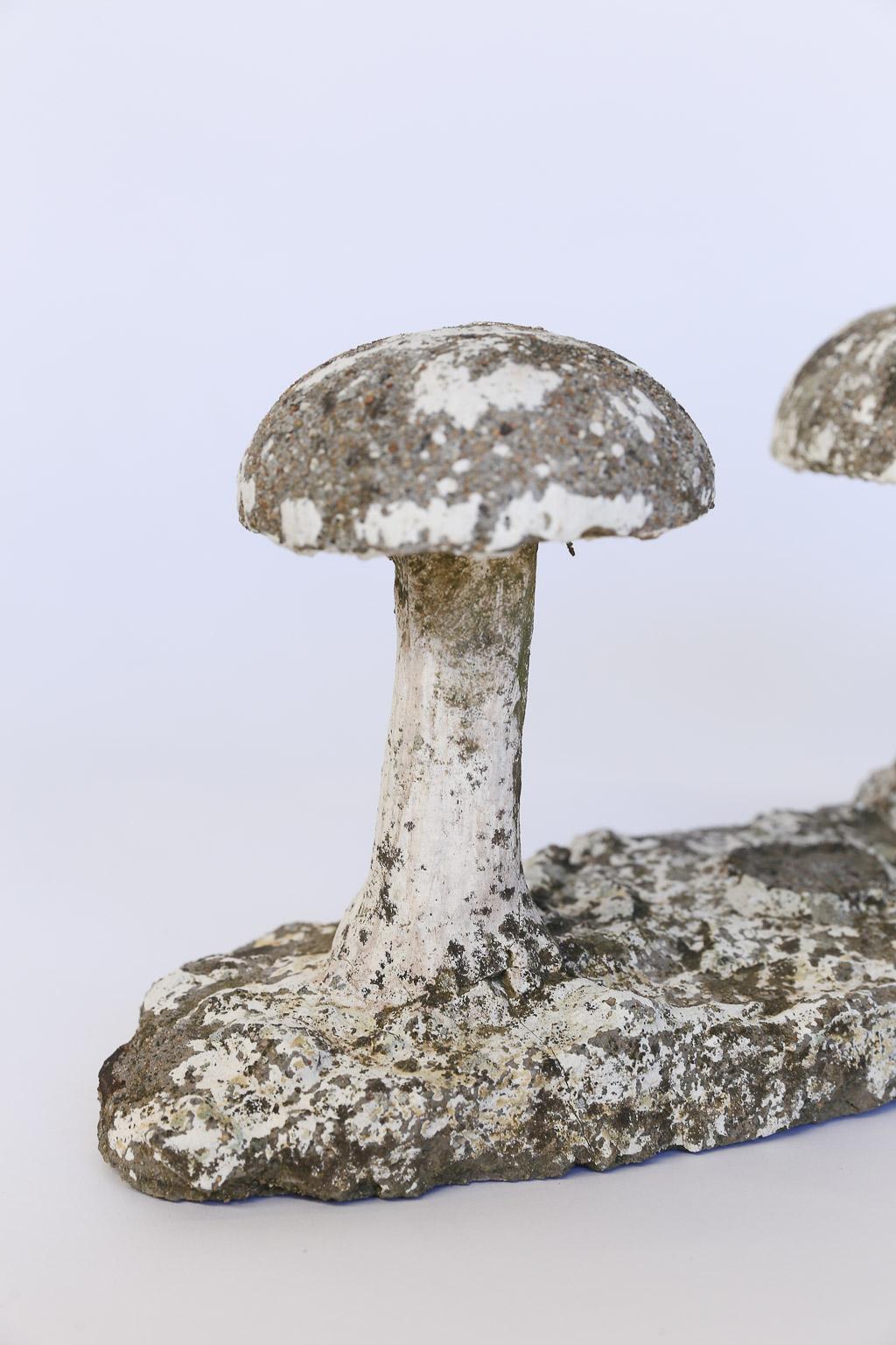 Found in France, two mushrooms in concrete stand ready to add a note of whimsy to your garden or tabletop. Well used and loved, there is evidence of a long ago third mushroom and a missing portion of the base which are no longer attached.