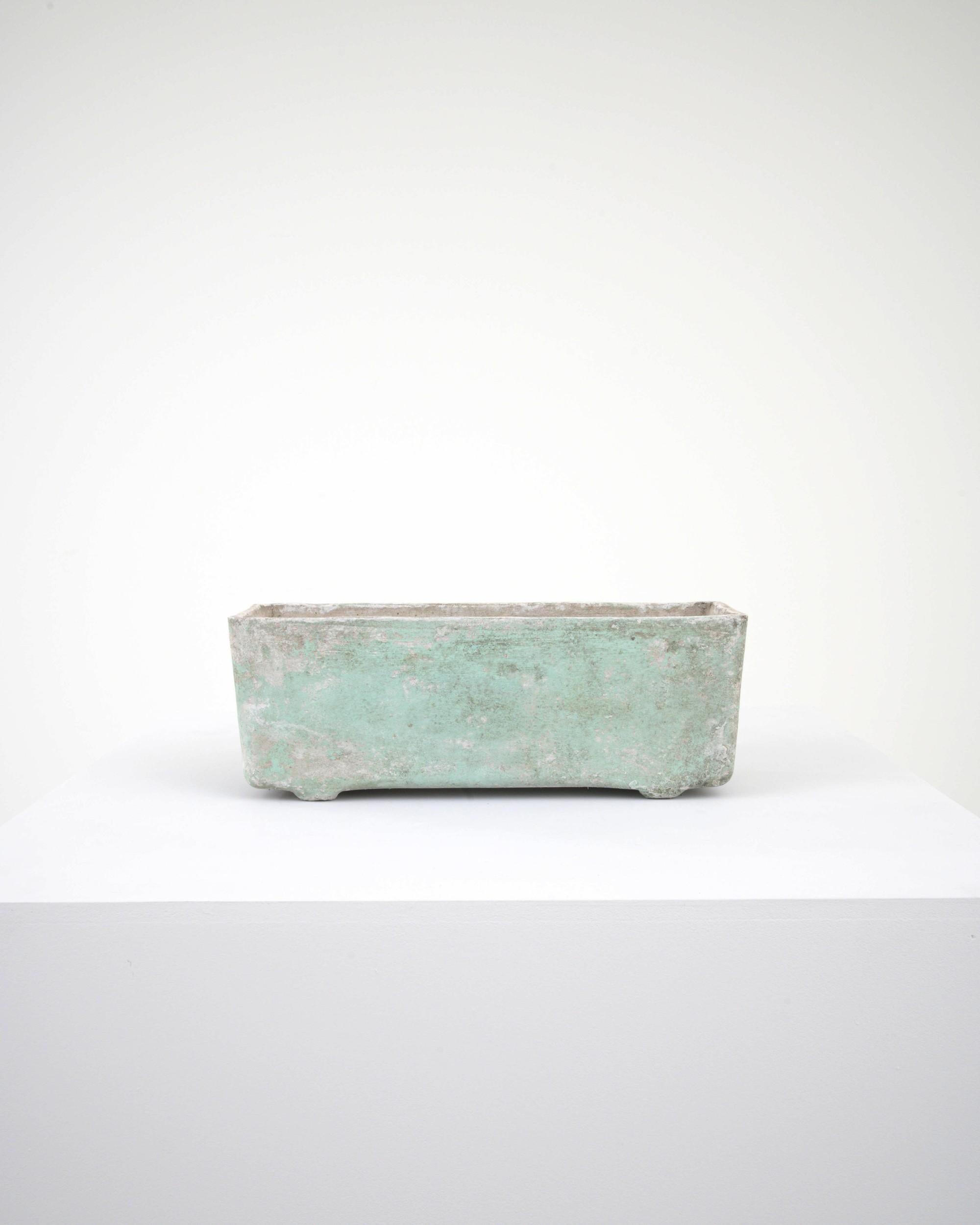 A minimalist shape combined with an evocative patina gives this vintage planter a unique personality. Made in France in the 1960s, a square container, unembellished save for indented feet, strips form back to its essentials. The attractive patina