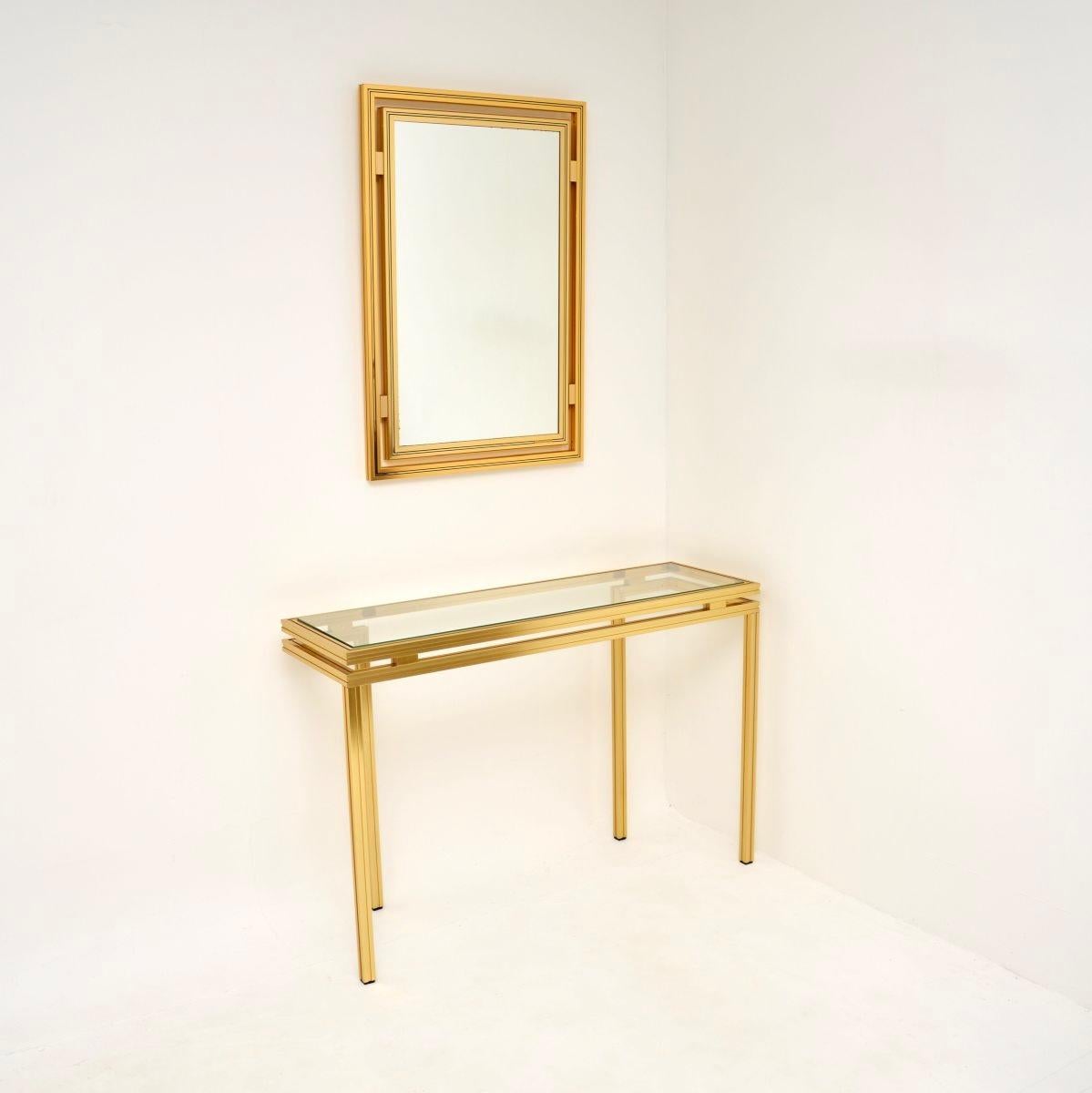 A stylish and very well made vintage French console table and mirror by Pierre Vandel. They were made in Paris, they date from the 1970’s.

The design is beautiful and practical, the frames are made from brushed brass tone aluminium, they are