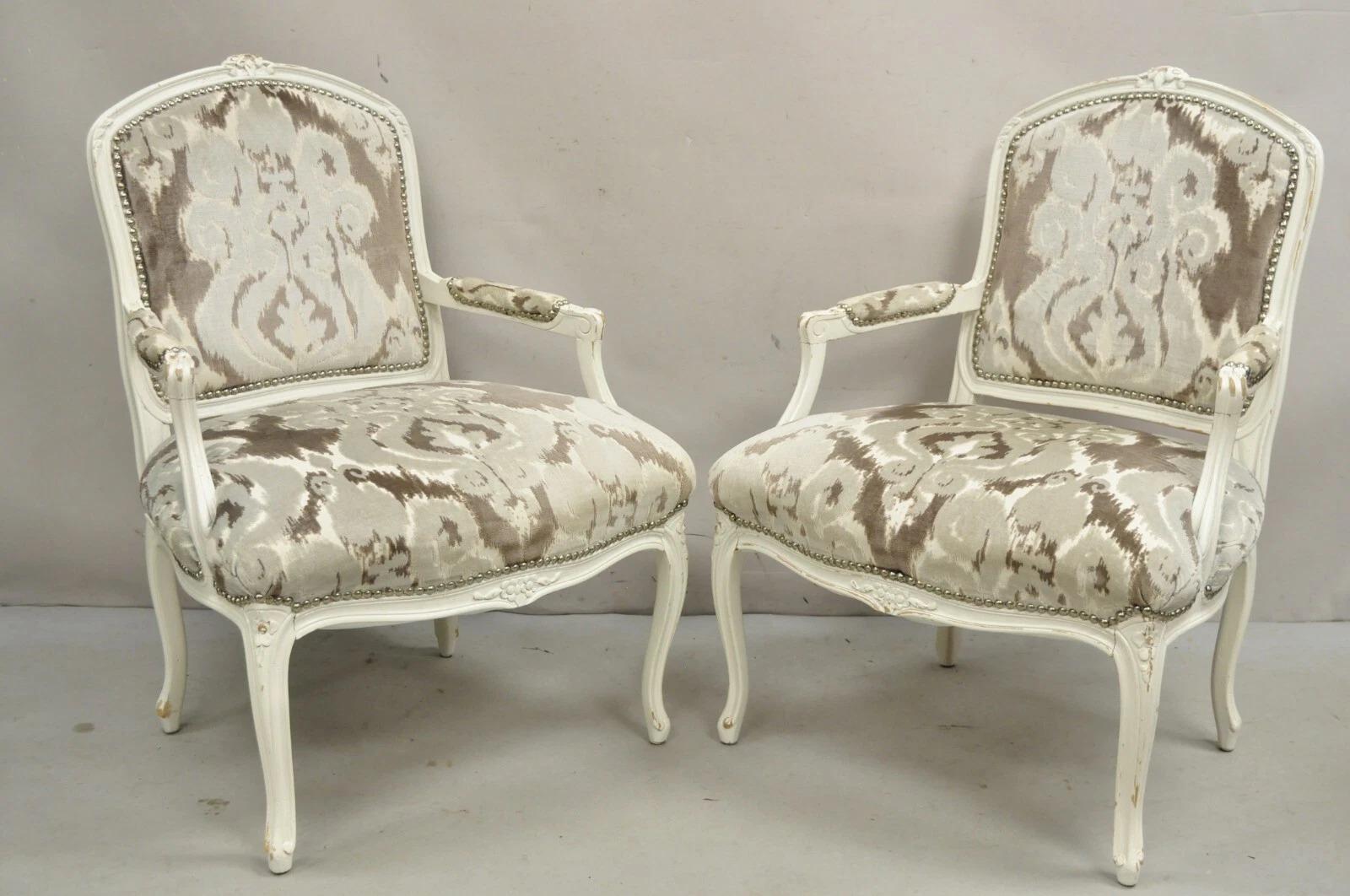 Vintage French Country Louis XV style Distress White Distress Painted Arm Chairs with Gray/Silver Printed Upholstery and Silver Nailhead Trim - a Pair. Circa Late 20th Century. Dimensions : 37