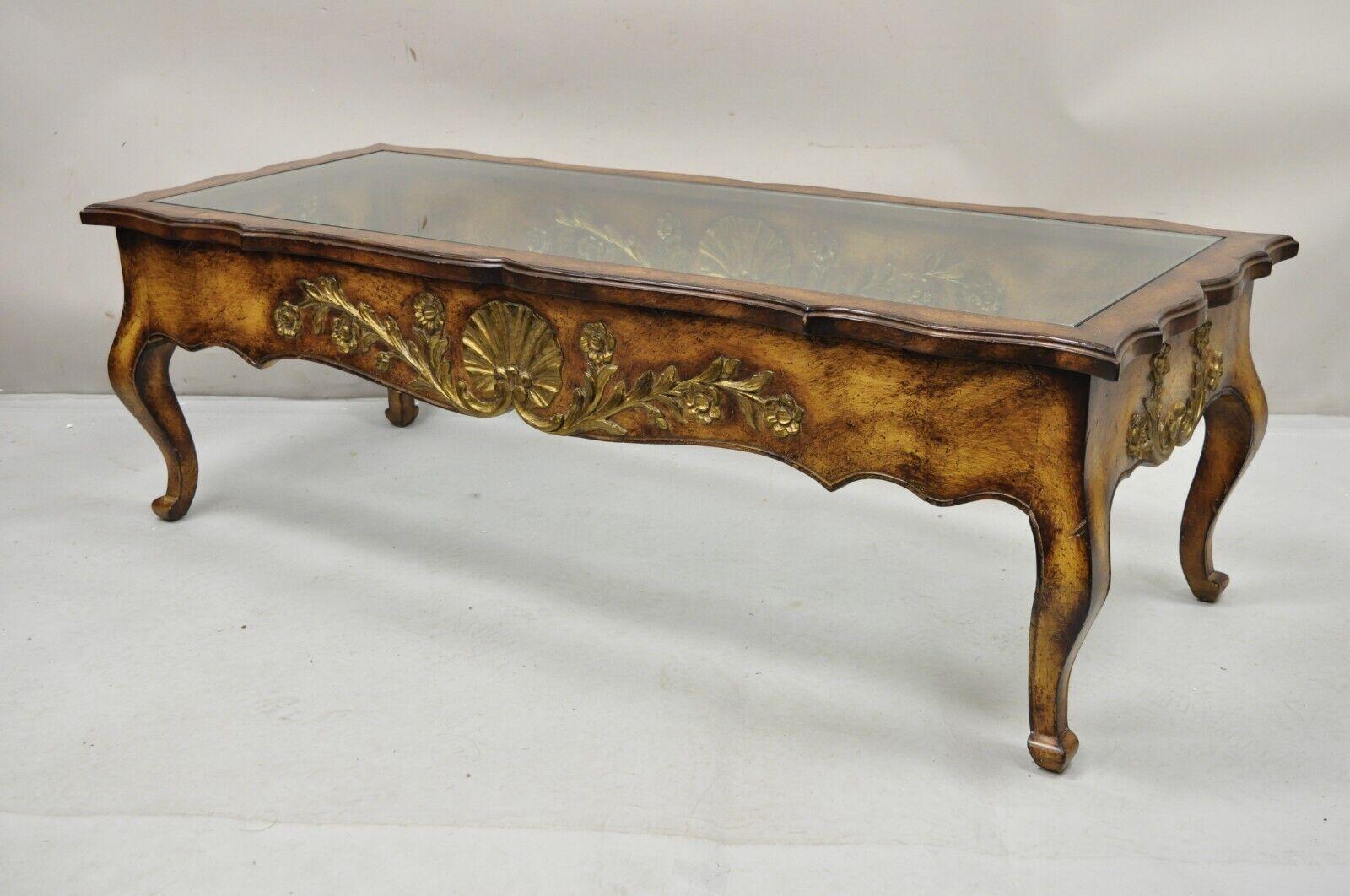 Vintage French Country Provincial Style Shell Carved Walnut Coffee Table. Item features a thick inset glass top, distressed finish, solid wood construction. Circa Late 20th Century. Measurements: 16.5