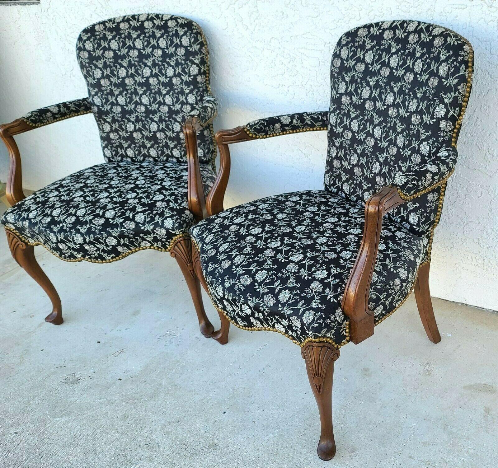 Offering one of our recent palm beach estate fine furniture acquisitions of a
Pair of vintage French country provincial walnut Fauteuil brass nail studded armchairs
Coloration is a very very dark blue which can look black in indoor