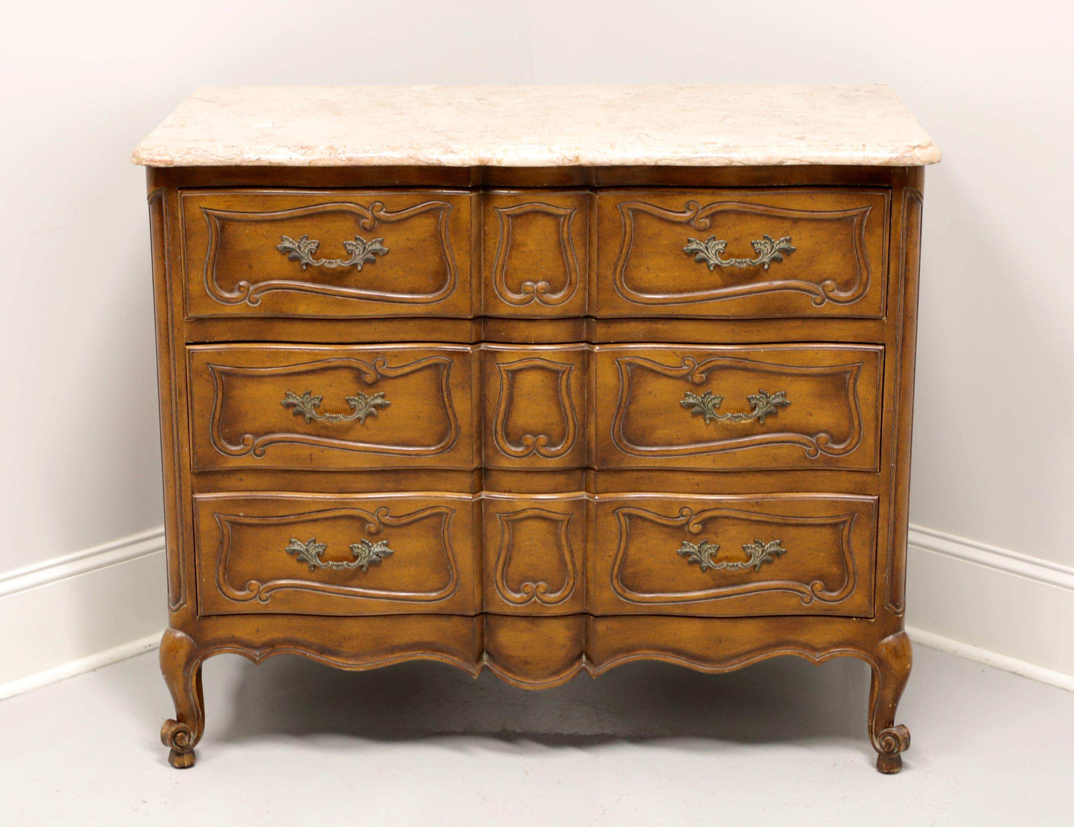 A French Country style bachelor chest, unbranded, similar quality to Thomasville or White Furniture. Fruitwood with antique brass hardware, marble top, carved drawer fronts, carved apron and scroll feet. Features three drawers of dovetail
