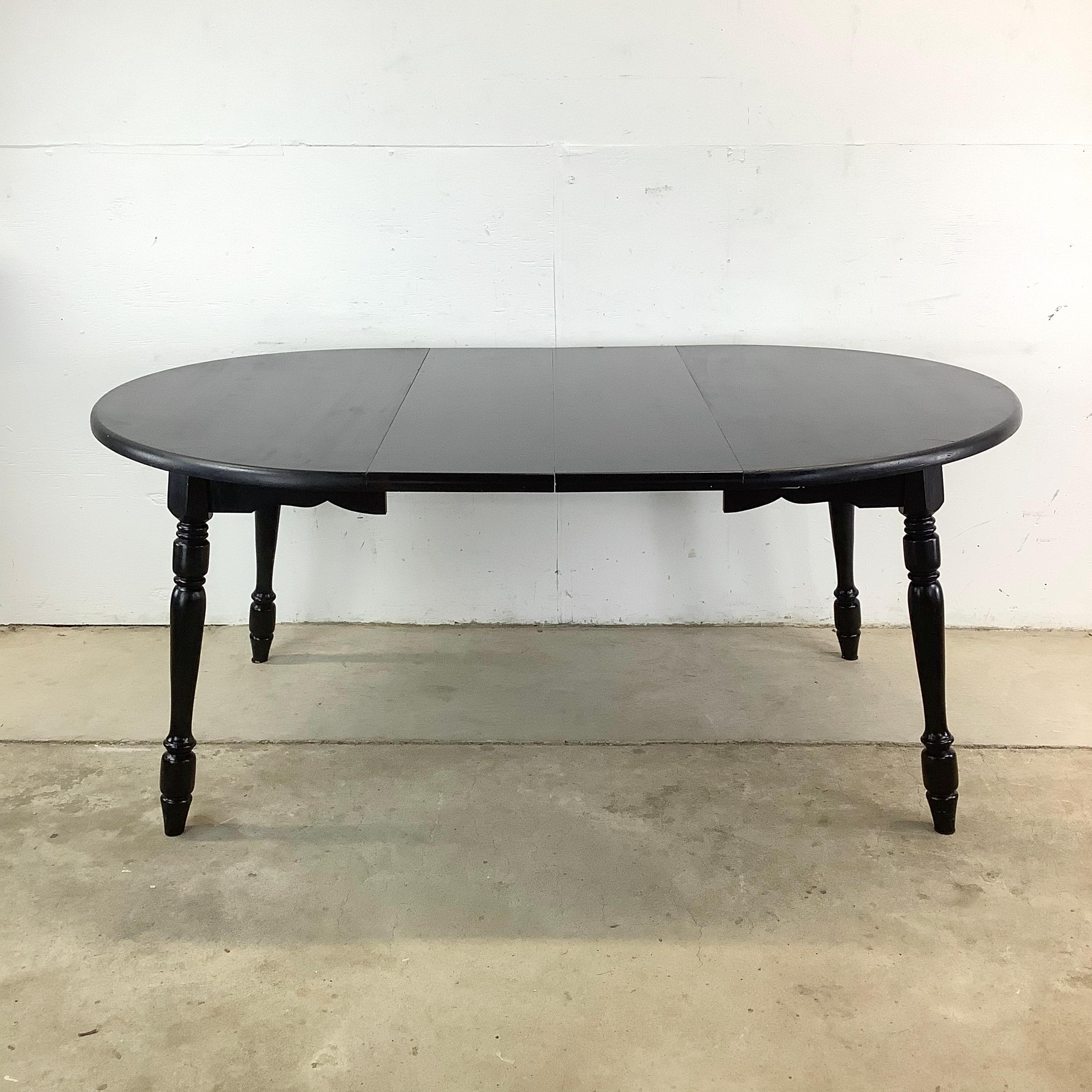 Elegant and adaptable, this vintage round dining table by Hale Company of Vermont is the perfect centerpiece for any dining space. With French Country-inspired fluted legs, a sleek black lacquer finish, and solid maple wood construction, this table