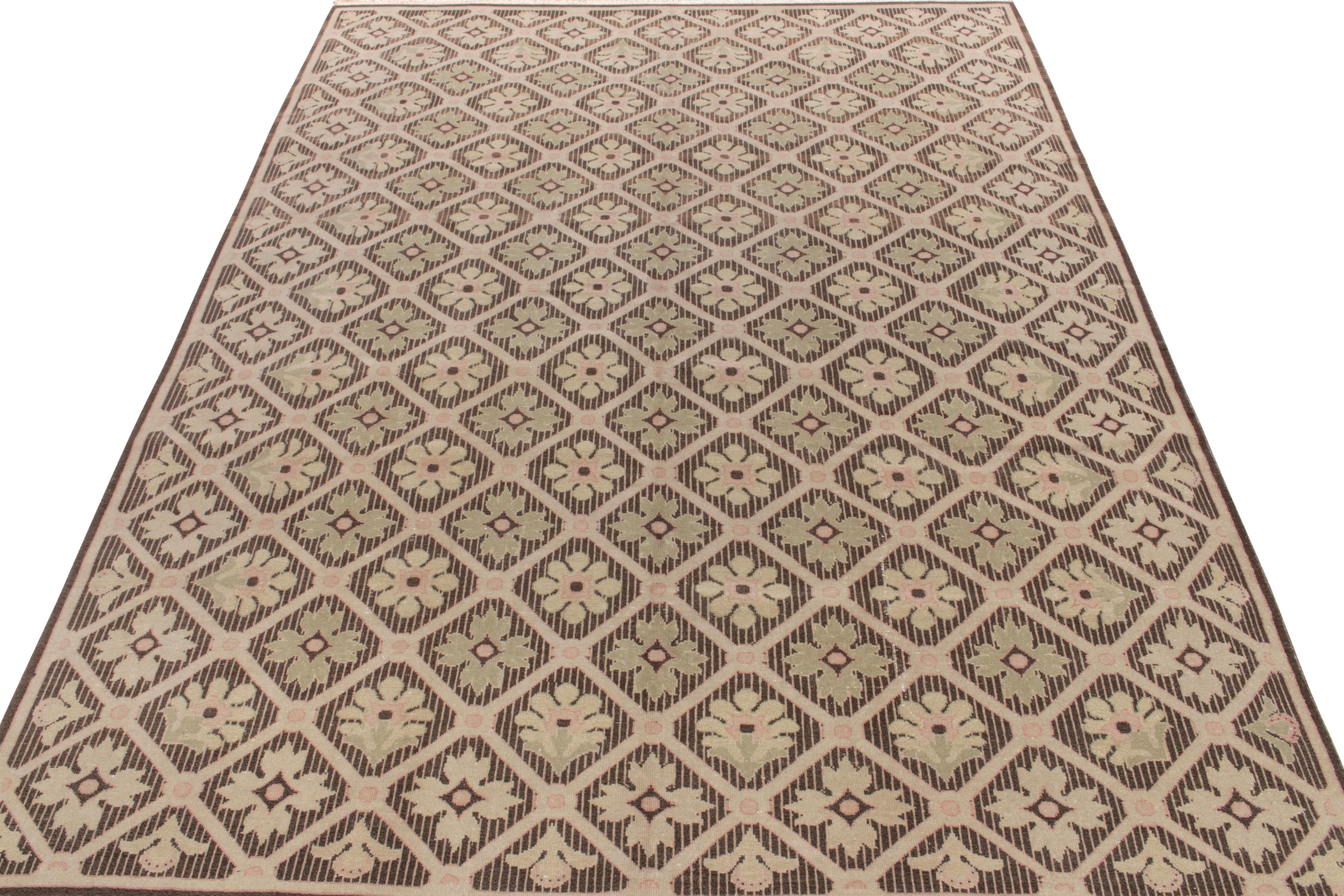 Hand-knotted in wool, a 9x12 vintage French country rug of the 1950s featuring a blend of delicious floral and geometric patterns in beige-brown with subtle pink and green hues—coming from the workshop of an acclaimed Romanian designer Abadjian. A