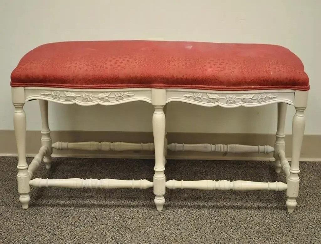 Vintage French Country Style White Carved Wood 6 Leg Upholstered Window Bench. Item features a six leg beautifully carved wood frame, white wash painted finish, stretcher supported base, and classic French country form. Circa Late 20th Century.