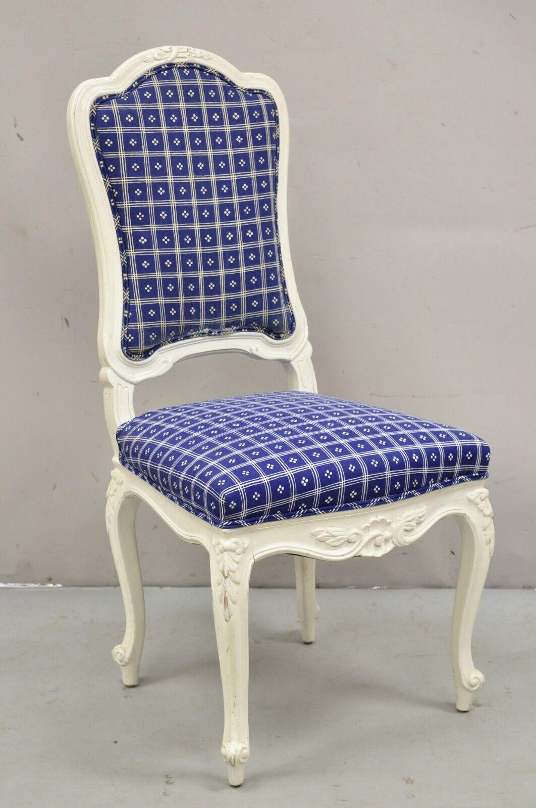Vintage French Country Style White Painted Carved Wood Dining Chairs - Set of 8. Item features solid wood frames, white distress painted finish, blue plaid upholstery, nicely carved details, very nice set of 8 American made armless dining chairs.