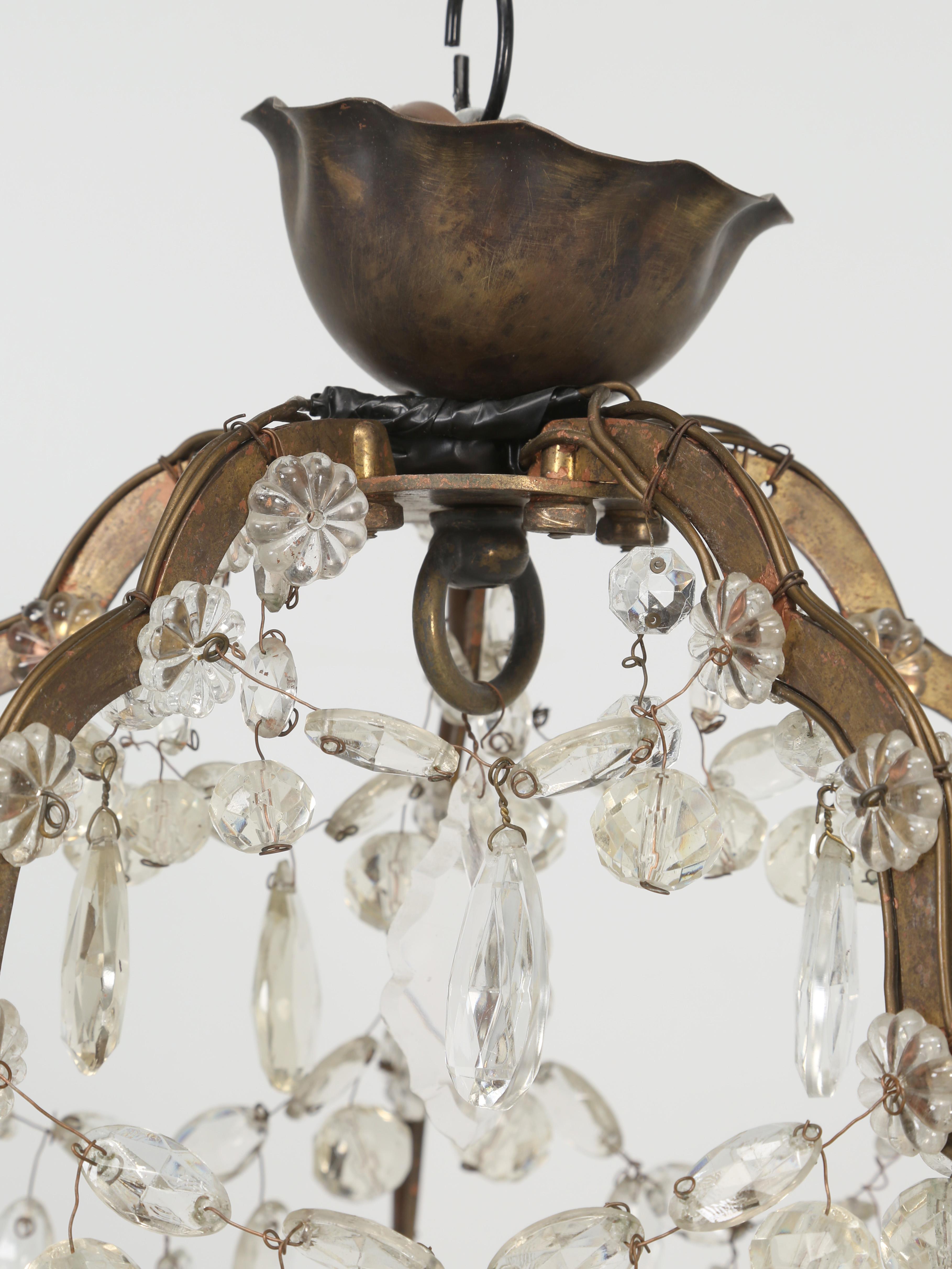 Vintage French crystal chandelier in as found, but working condition. Missing several crystals and priced accordingly. 
**Height provided does not include the canopy. The canopy is 2.5