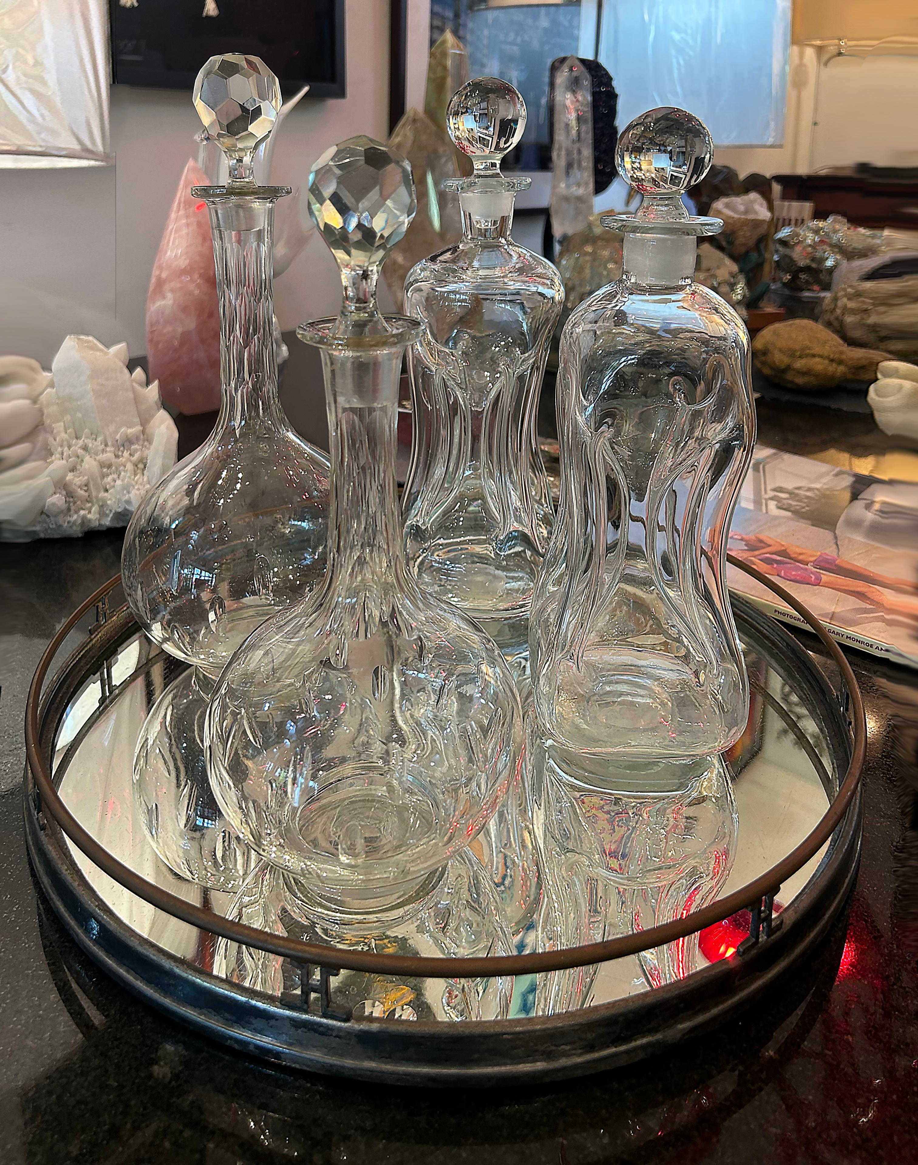 

Offred for sale is a set of 2 elegant hand-blown and cut crystal decanters attributed to Val Saint Lambert.  The decanters are matching in staggered sizes with bulbous bottoms decorated in polished oval cut designs.  The necks are copper wheel cut