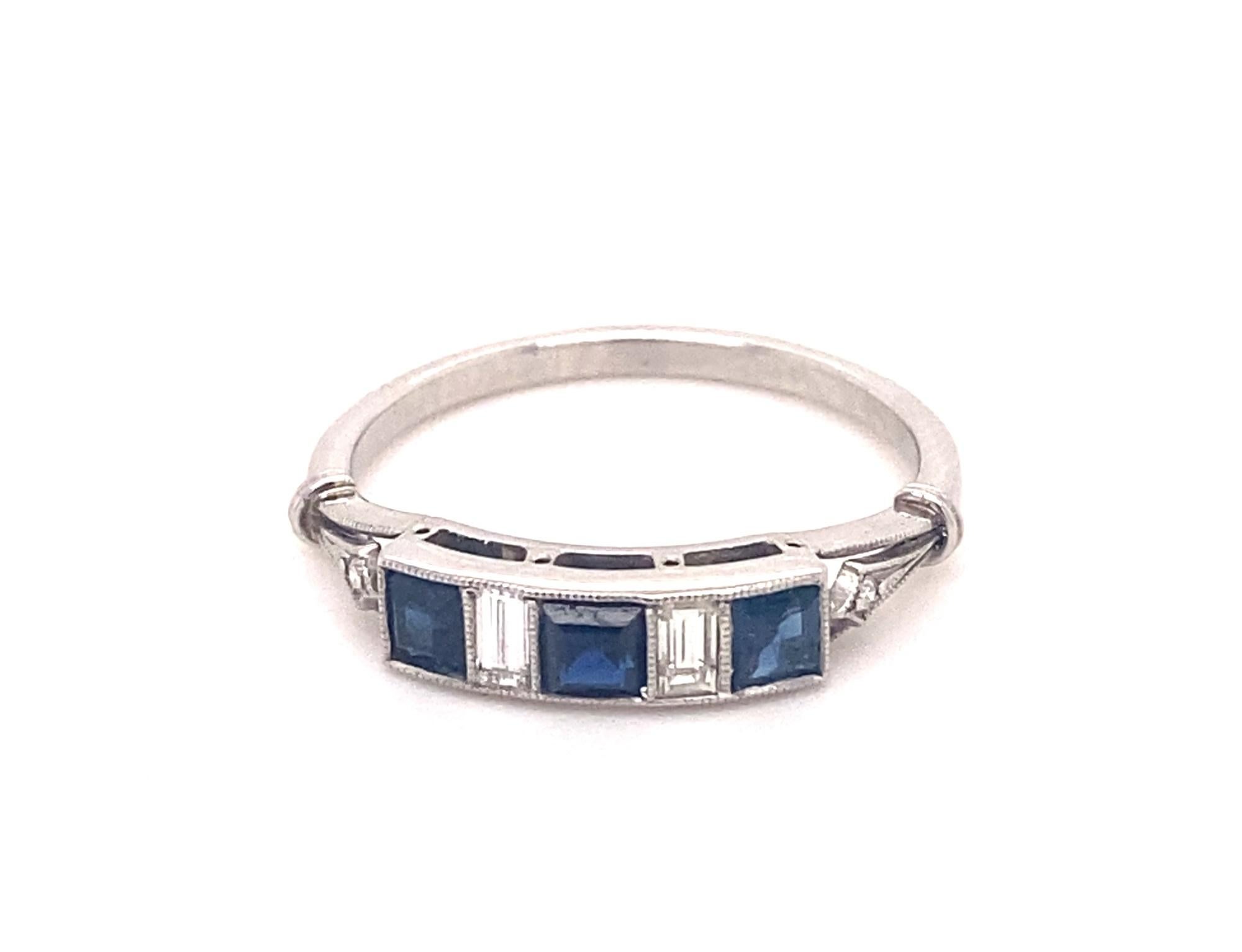 This is a stunning vintage ring set with 3 emerald Cut Sapphires and 2 French cut diamonds in platinum.  The sapphires are natural blue gem quality nice deep blue color and good clarity.  The diamonds average H color VS-2 clarity, total gem weight