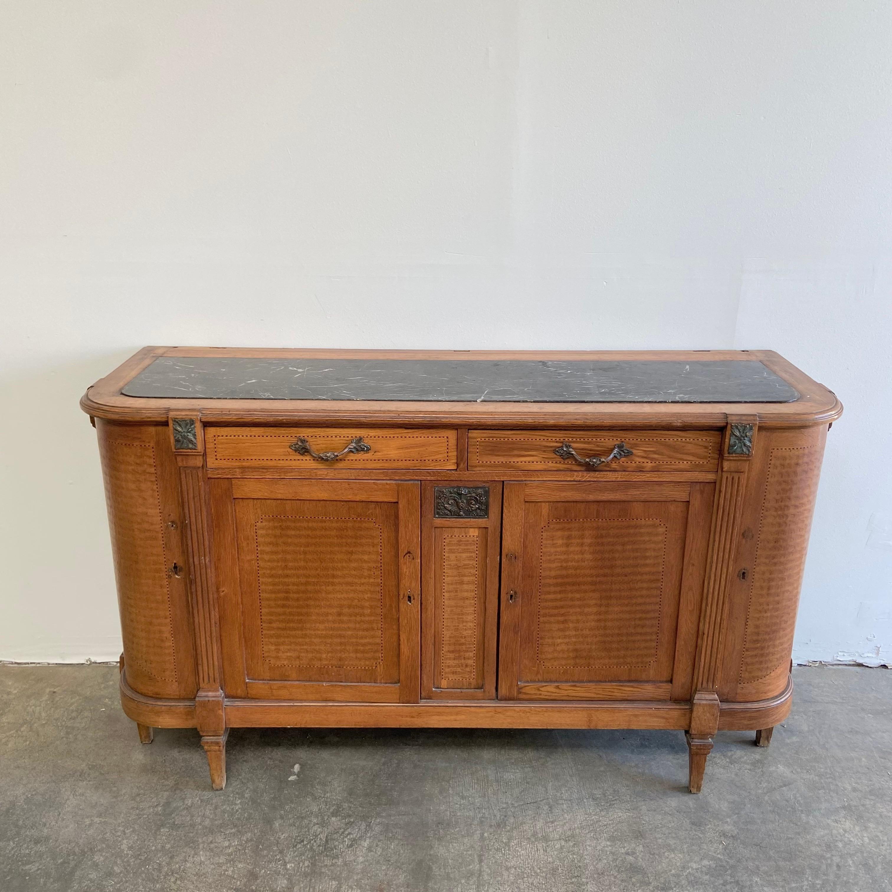 Antique Inlay fruitwood buffet with an art deco flair.
Marble top, with plenty of storage, inside features shelving, with side doors at the corner for more storage.
The top has 2 drawers that open and close with ease.
server measures: 67”W x 22”D