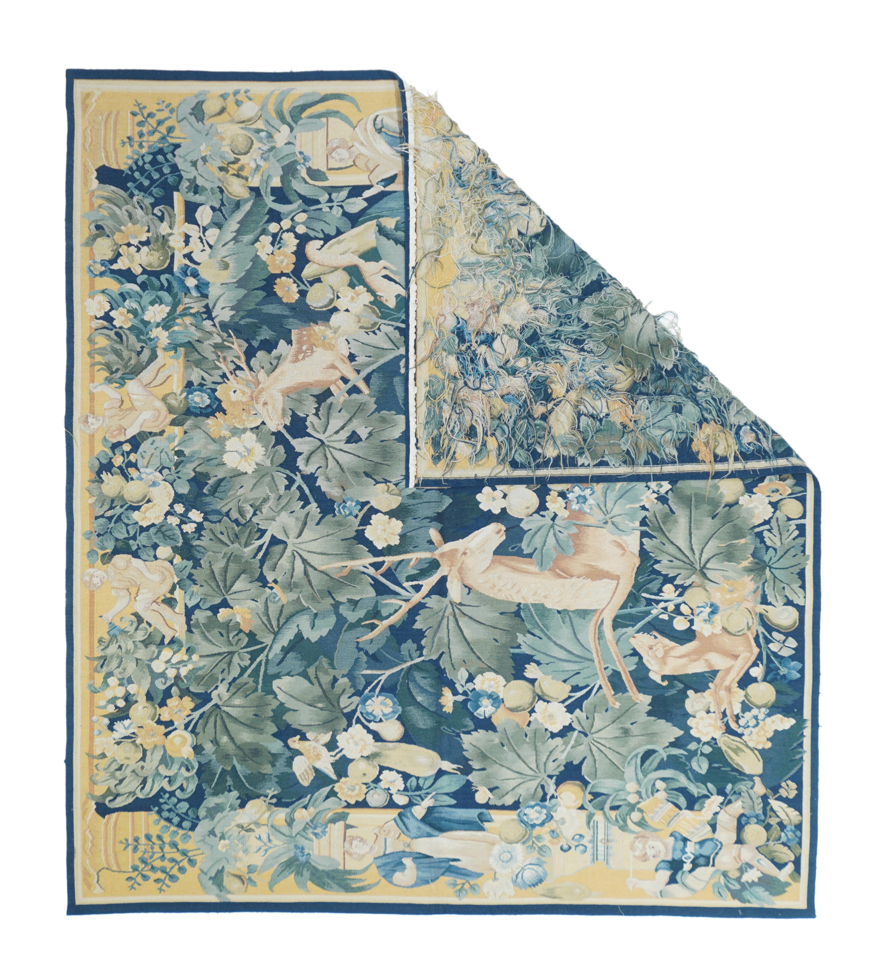 This is a modern interpretation of the Flemish Large Leaf Verdure hangings especially popular in the mid-16th century.
The dark blue ground is nearly covered by lobed grape vine leaves, stems with small flowers and fruits, and a lavishly antlered