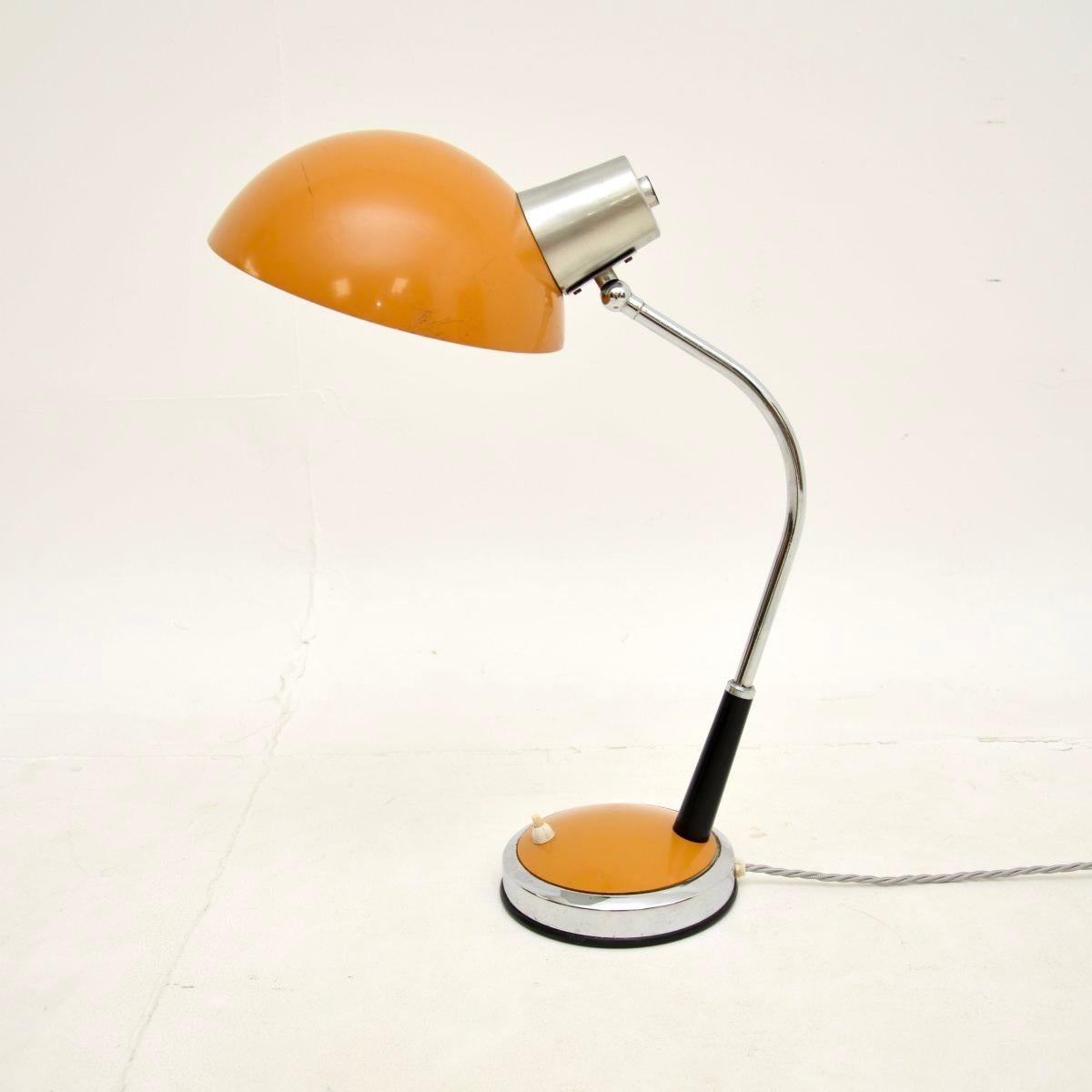 A smart and stylish vintage French desk lamp, dating from around the 1960’s.

This is of excellent quality, it is a good size and has a beautiful design. The shade and base are a gorgeous muted orange tone, complimented nicely with black and chrome.