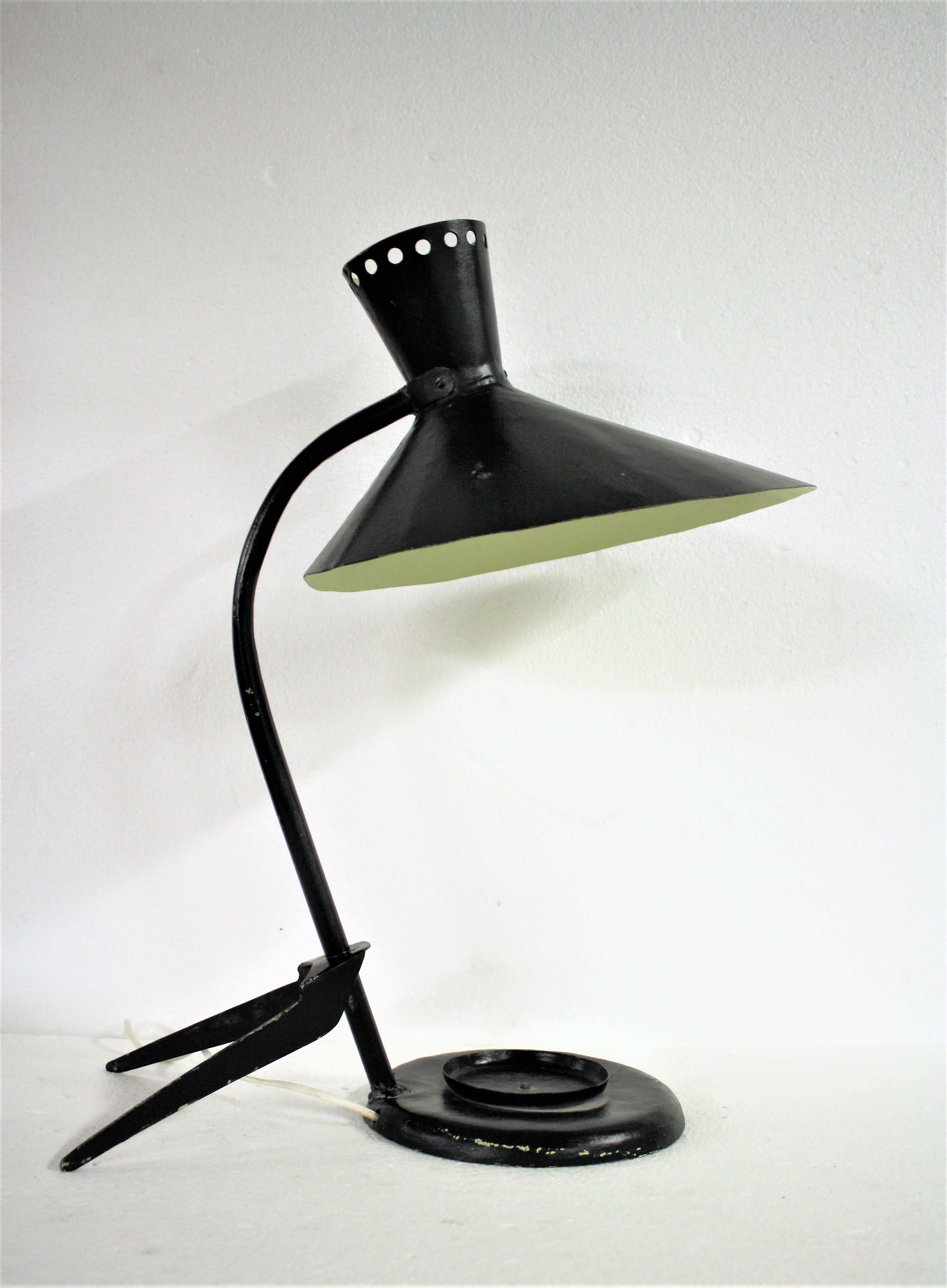 Huge Mid-Century Modern desk lamp.

This beautiful tripod design lamp was probably designed by Jean Boris Lacroix, although this is not confirmed.

It has a lot of similar design features.

The lamp features a diabolo design shade with