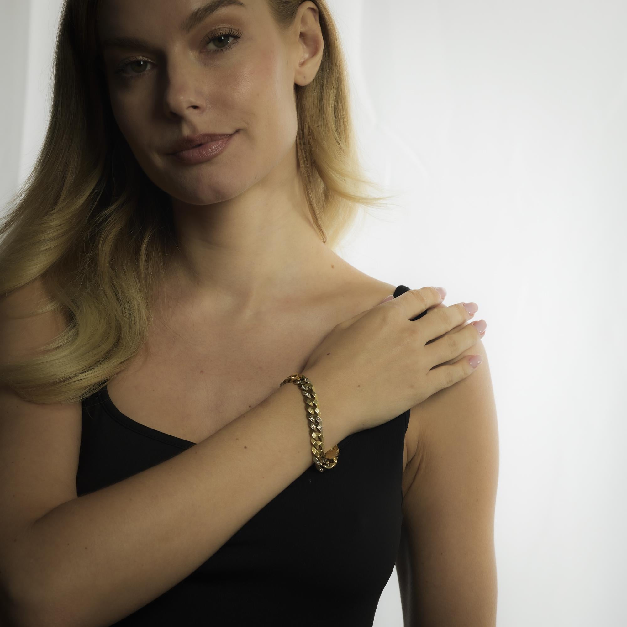 This vintage French bracelet in 18k yellow and white gold features .70 carats of round brilliant cut diamonds, blending timeless sparkle with bold 1970’s sophistication.