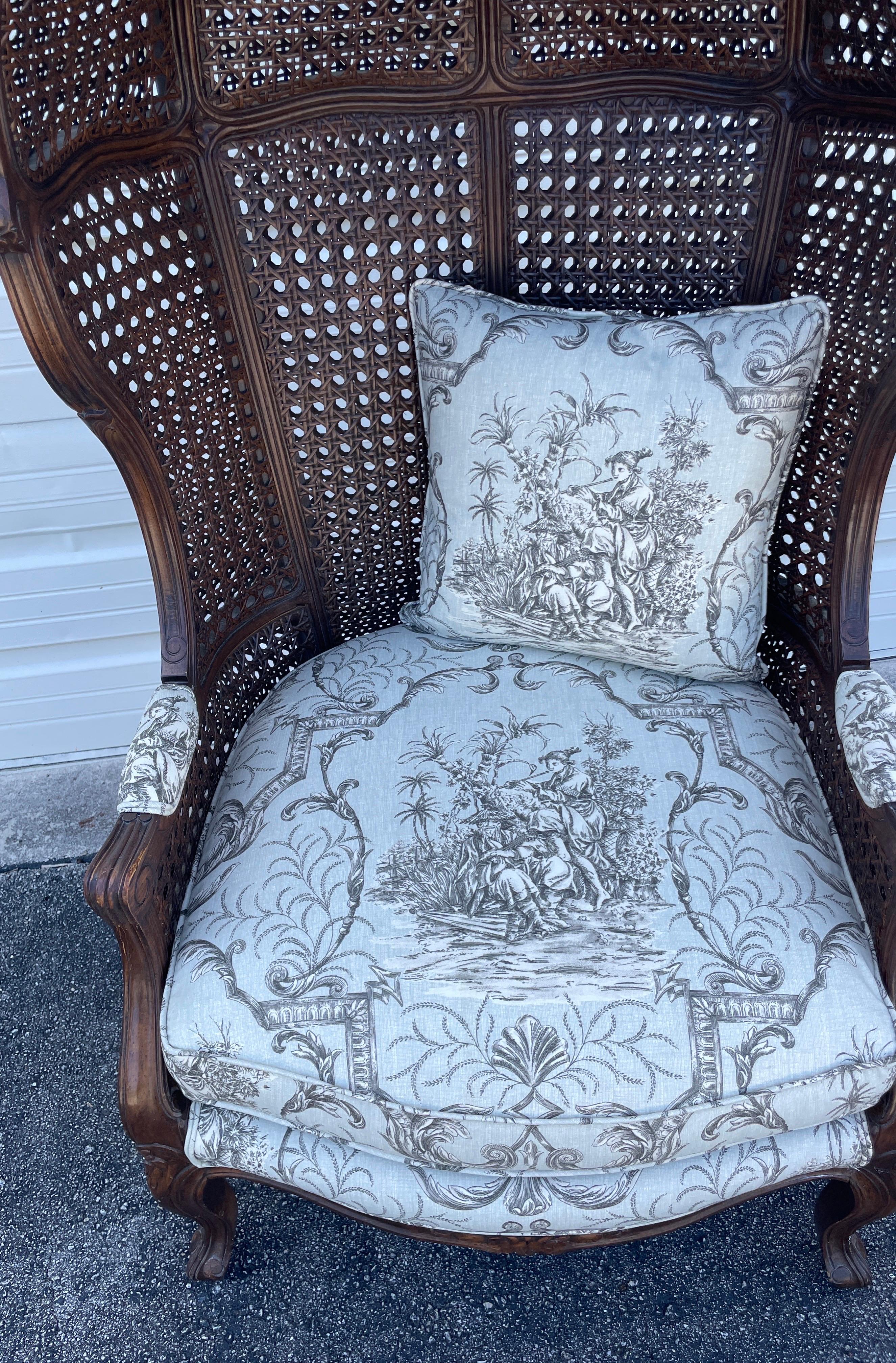Vintage double caned French Hooded or Porters chair with newly upholstered Scalamandre Toile Fabric. 