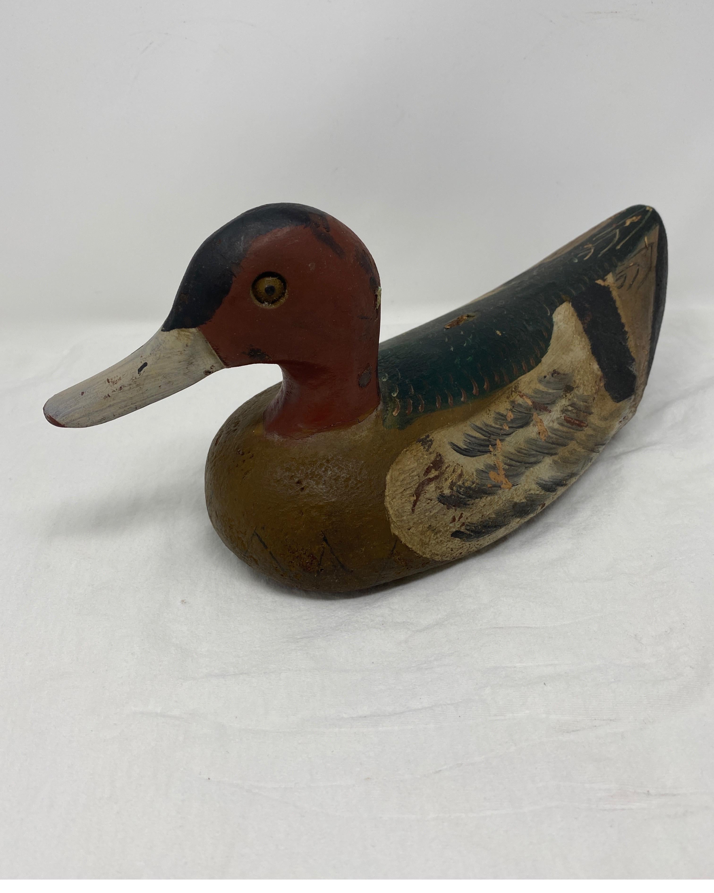 Found in France, this vintage duck decoy is truly a one of a kind find for the collector. The duck has been hand carved and painted for a realistic look to attract live ducks. This piece would make a perfect gift for the collector or hunter.